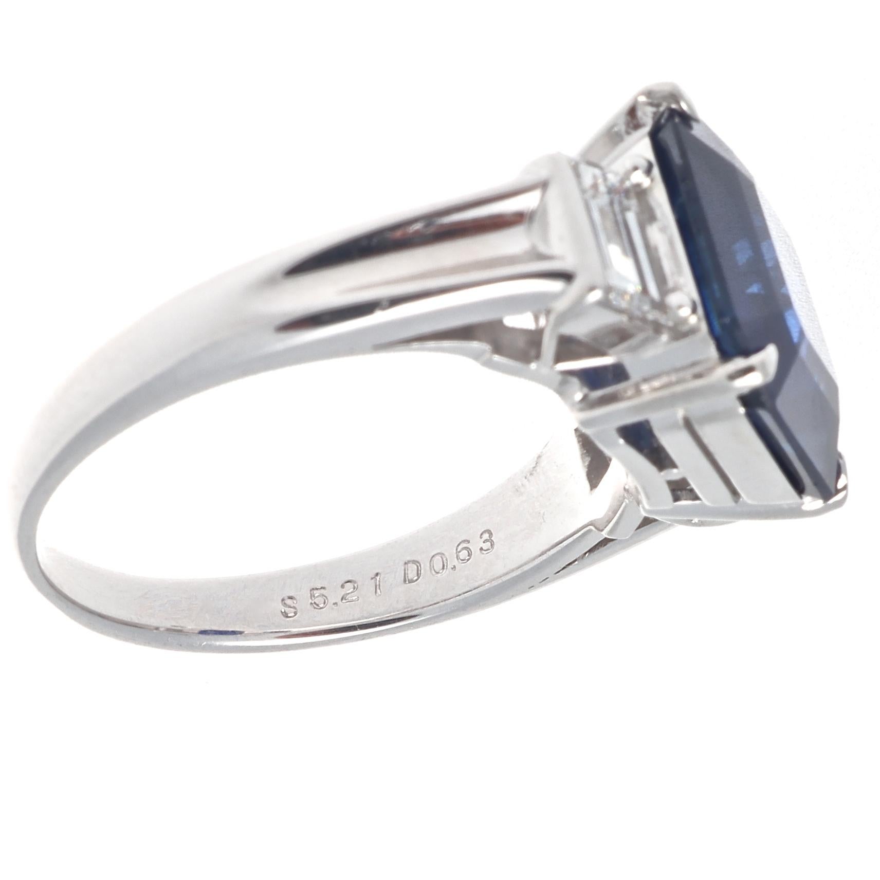 A modern version of the classic engagement ring. Featuring a 5.21 carat octagonal cut sapphire that is accompanied with an AIGS certificate stating it is a natural royal blue sapphire from the Madagascar region with indications of heating. Accented