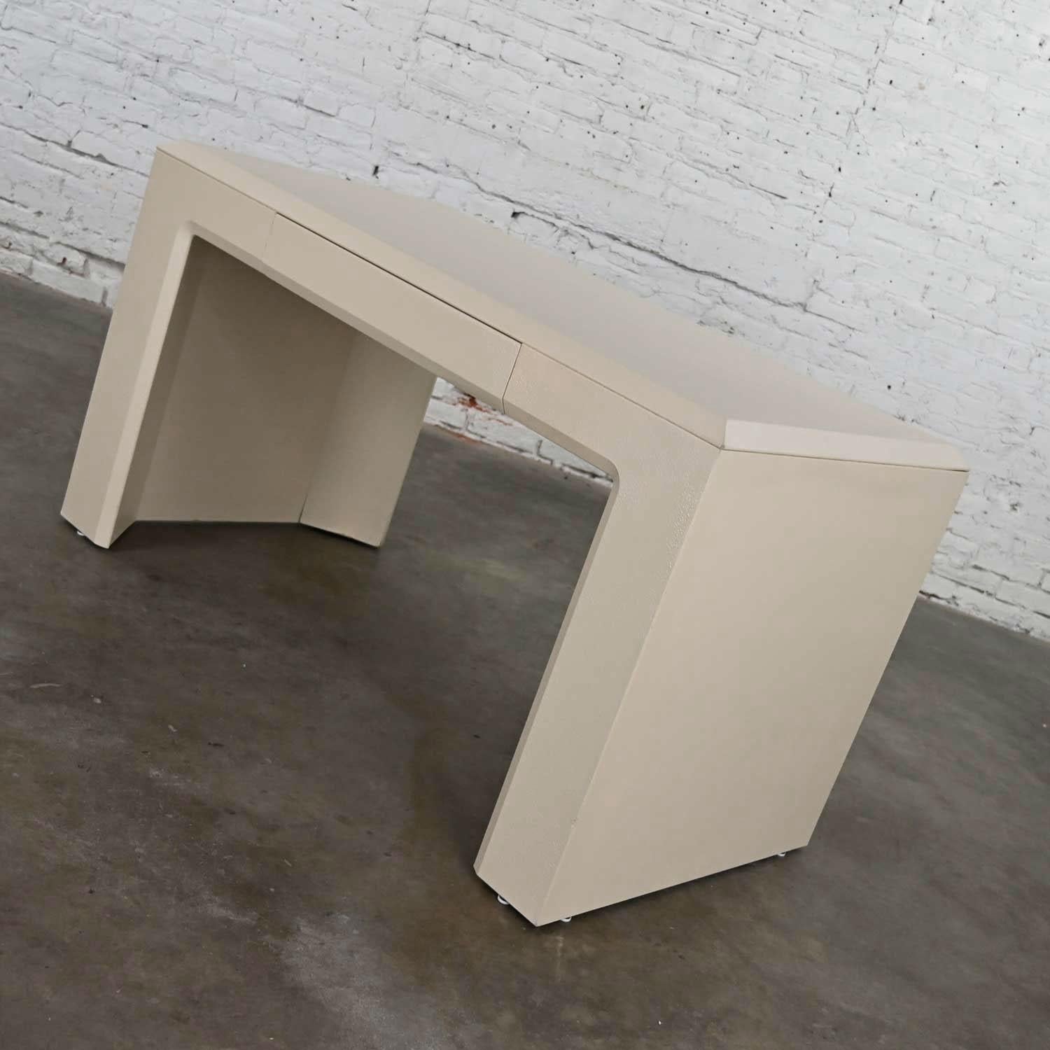 Handsome modern off-white waterfall style writing desk by Lane Alta Vista. All over faux shagreen texture and restored with a new antique white painted finish. Beautiful condition, keeping in mind that this is vintage and not new so will have signs