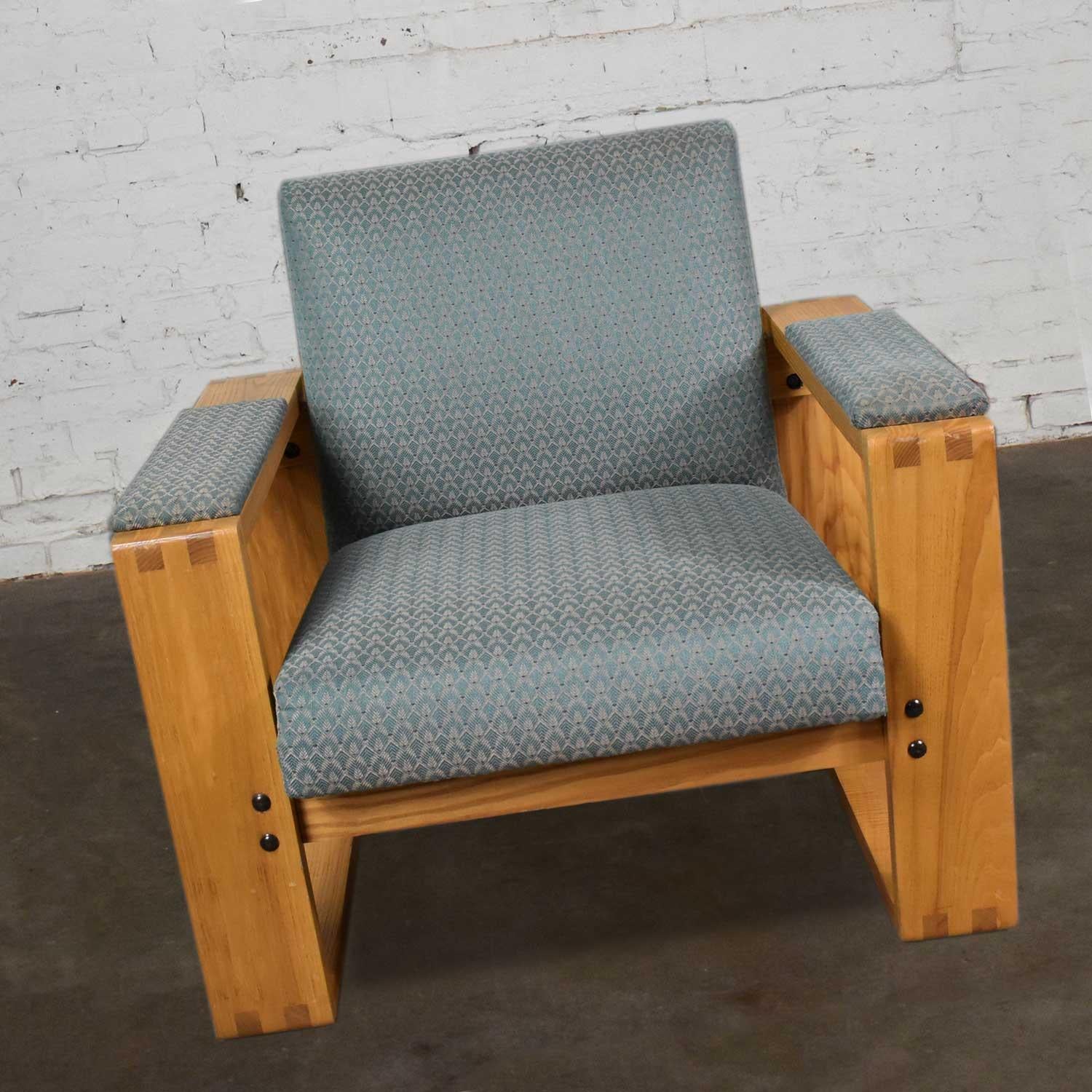 Handsome modern oak open frame club chair with a floating upholstered seat and back. There are eight available and we are pricing them per chair. They are all in good vintage condition. The wood is in wonderful condition but most of the teal fabric