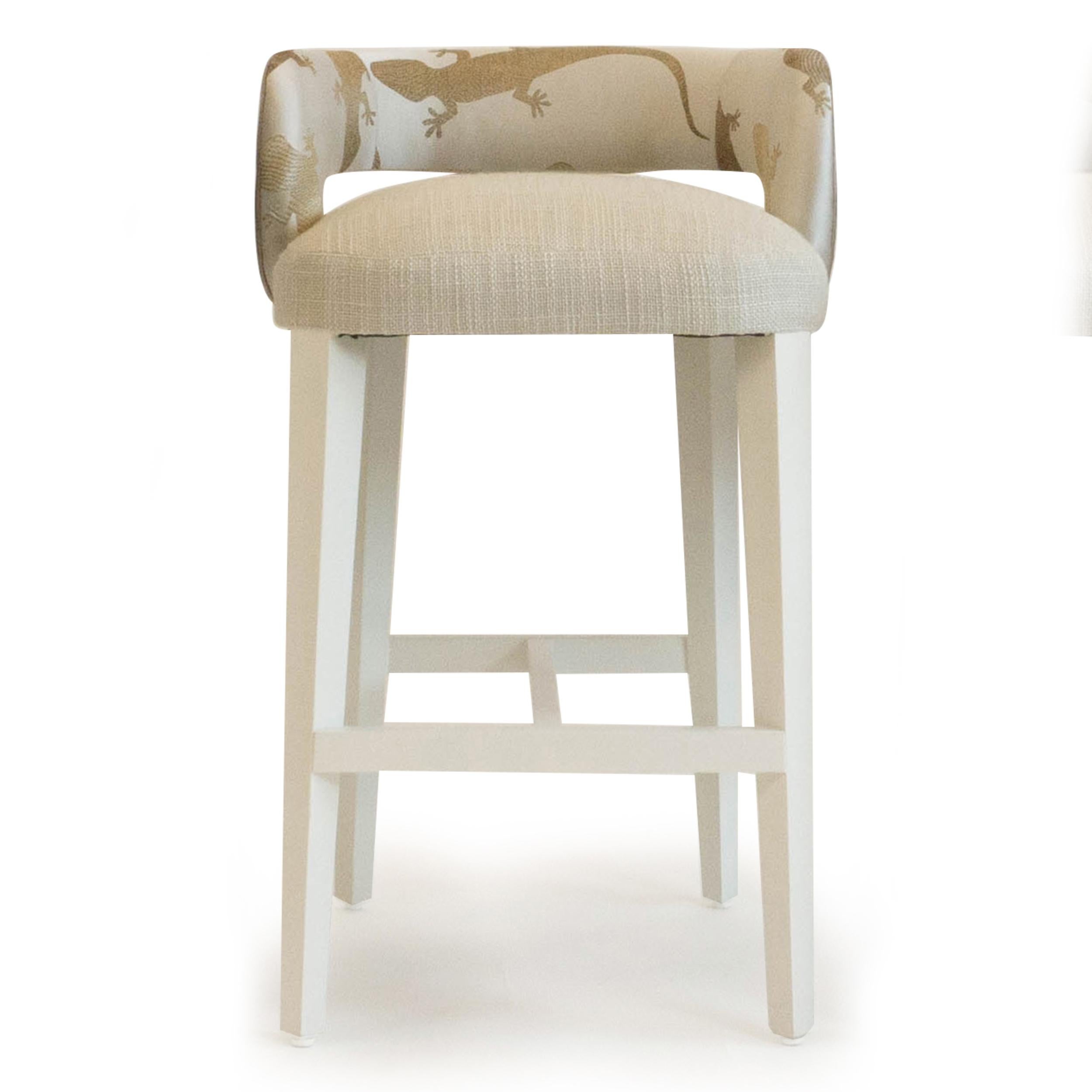 Low open back bench seat counter stool upholstered in a combination of a silk and poly blend Romo fabric with salamander print, linen on the seat and vinyl on the back. Legs painted in marine lacquer. Seat cushion is made with a deep firm foam. Can