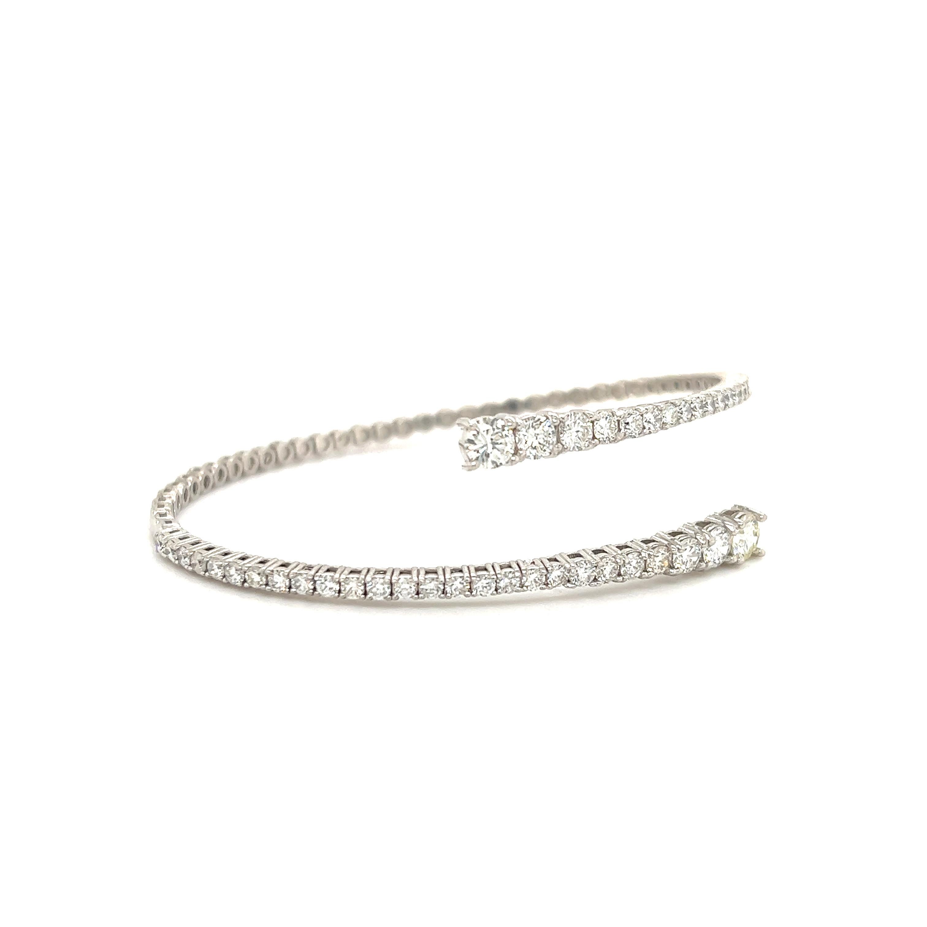 Fantastic creation crafted in house by us Roc Diamonds. The flex fit diamond bangle is crafted in 14k white gold. The bangle is flexible as the bottom portion has a spring design. The bangle is set with 3.36 ct. of natural round brilliant cut