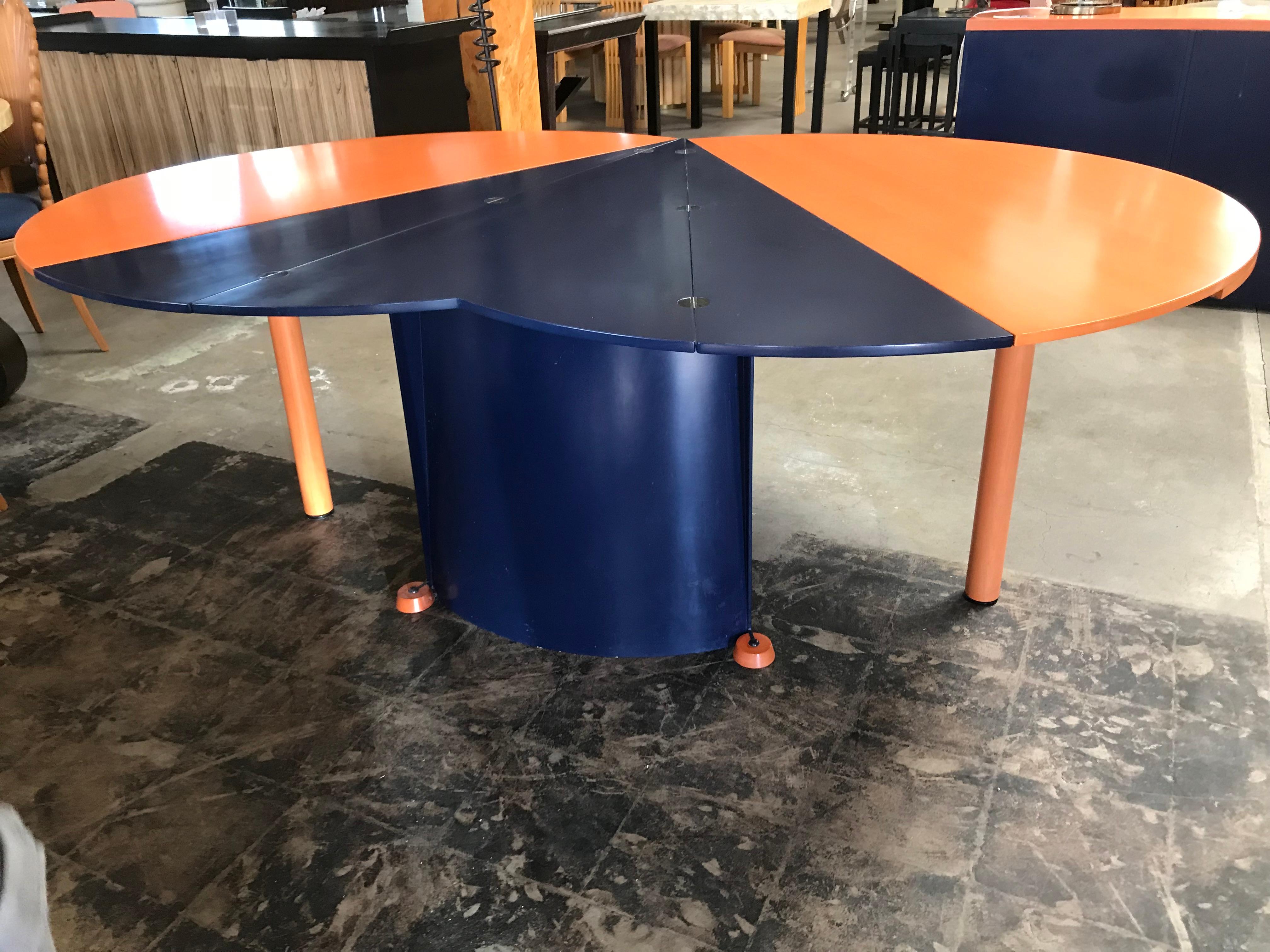 One of kind two-toned dining table in terracotta orange and navy blue stained wood, manufactured by Castelijn Meubelindustrie in the Netherlands. 
It folds into a smaller round table (diameter: 51
