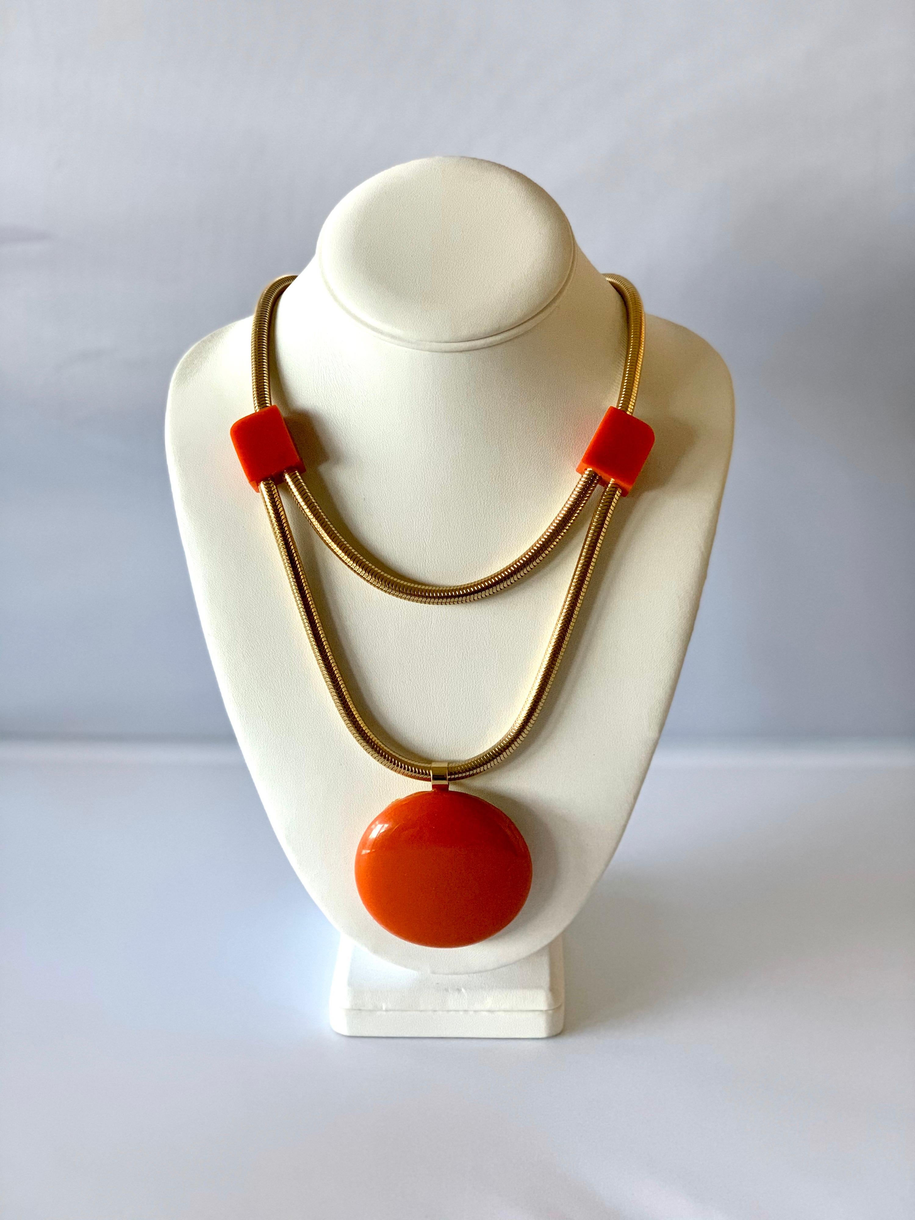 Modern orange Bakelite statement necklace by Castillo for Lanvin, Paris circa 1960 - the necklace is comprised out of a double gold snake chain which is adorned by three orange geometric phenolic elements. Two small squares and a large circular