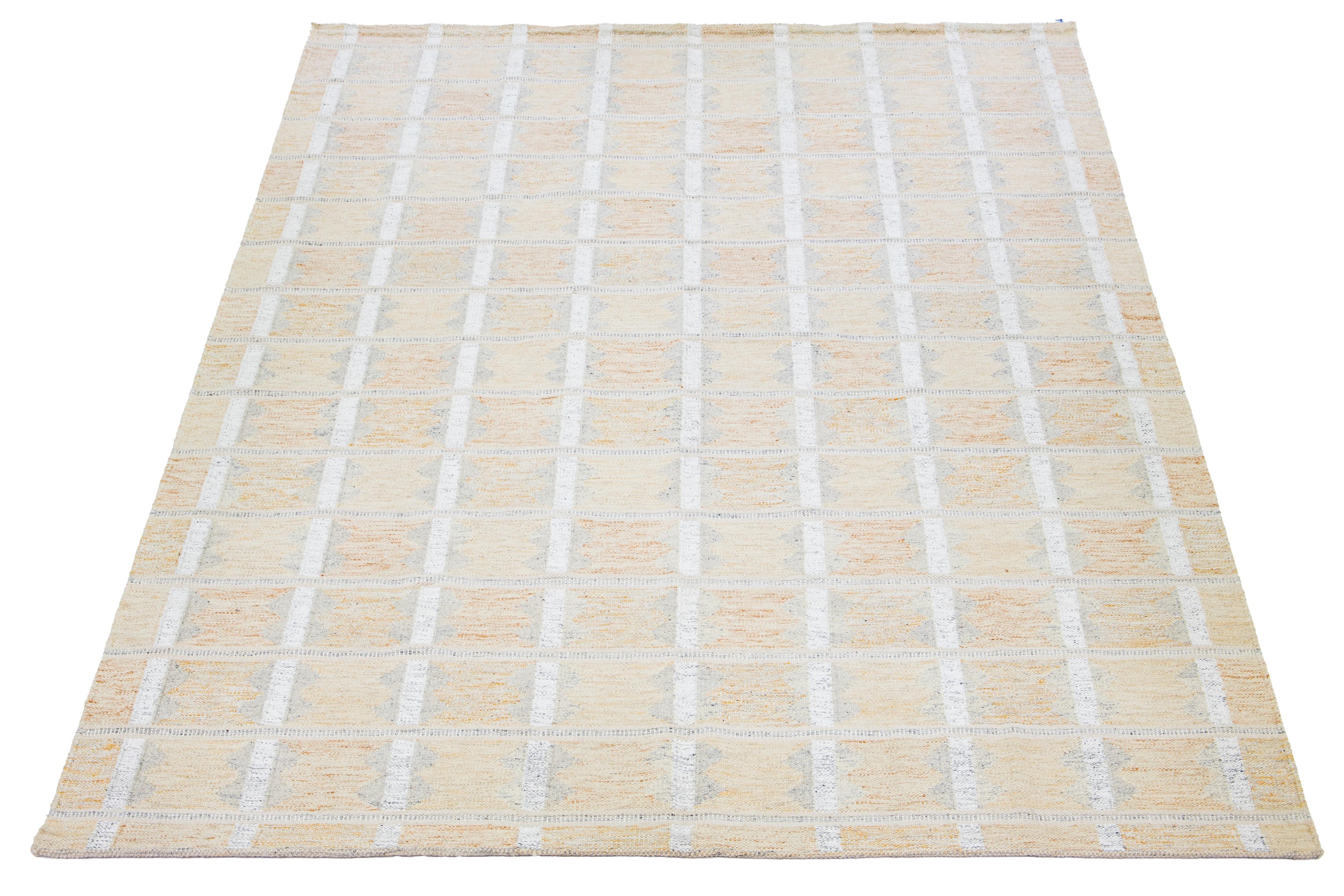 This flatweave rug features a chic contemporary Swedish design with an orange field color. It has a geometric pattern throughout the rug in ivory and gray shades.

 This rug measures 10'2