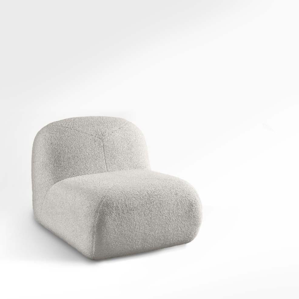 A modern reinterpretation of a mid-century boucle lounge chair. Living up to its curvy appearance, the Kumura lounge chair is beautiful and super comfortable. This contemporary chaise longue's design reaches into the trendy shapes of organic design
