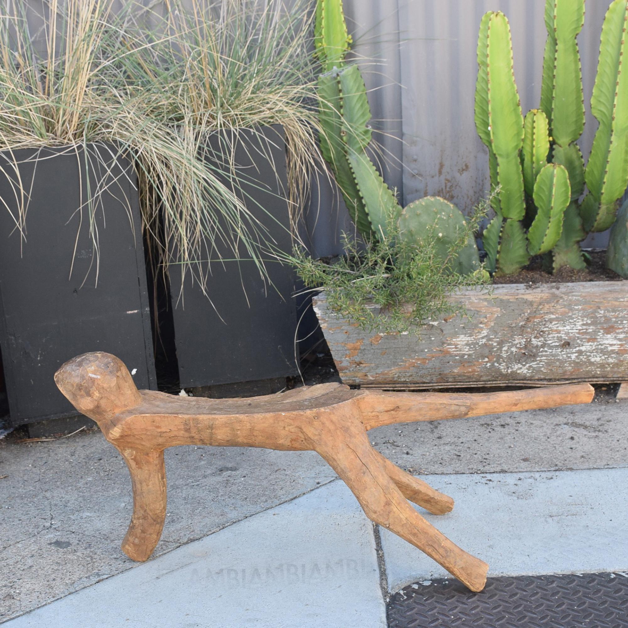 1970s Modernist Milking Stool French style Pierre Jeanneret
sculptural art piece low tripod stool.
Hand carved wood
Unmarked
11.5 L X 25 D x 15 T.
Wear consistent with age and use. Minor fading. 
Original vintage unrestored preowned condition.
Refer