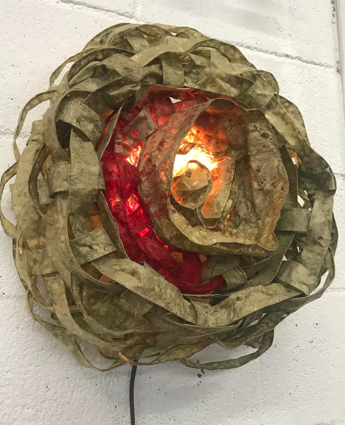 HanaHana wall light. Handmade paper, woven in a basketweave manner, with undulating curves, creating an organic round shape and interesting light play on wall when lit. Designed and made by paper artist Yuri Kinoshita.
Can be made in different