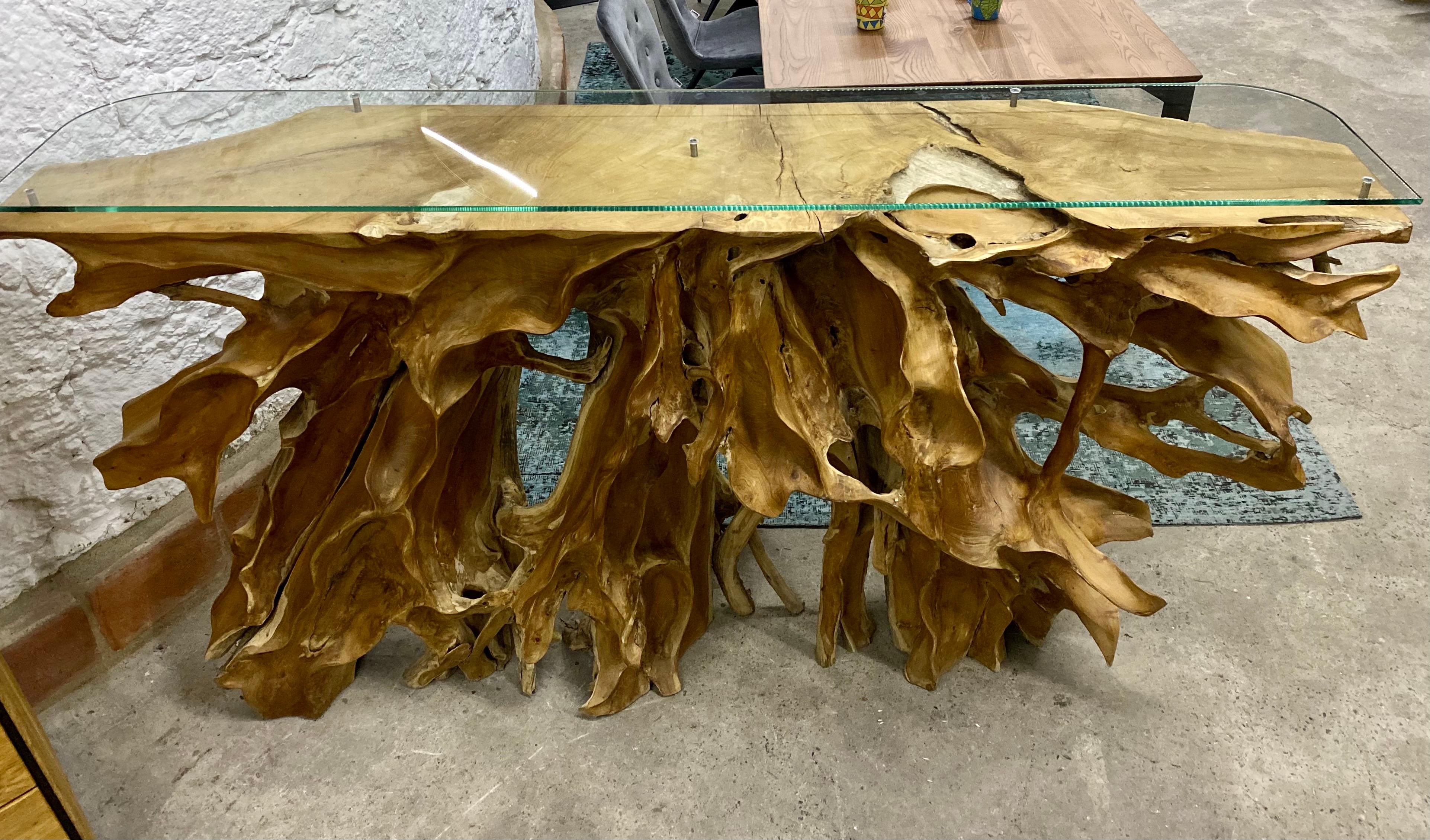 Extraordinary organic modern teak root console/ sideboard toped by a safety glass panel. A contemporary organic console table with outstanding appearance. Artfully cutted out of a large teak root and elaborately hand-sanded by the artist, this