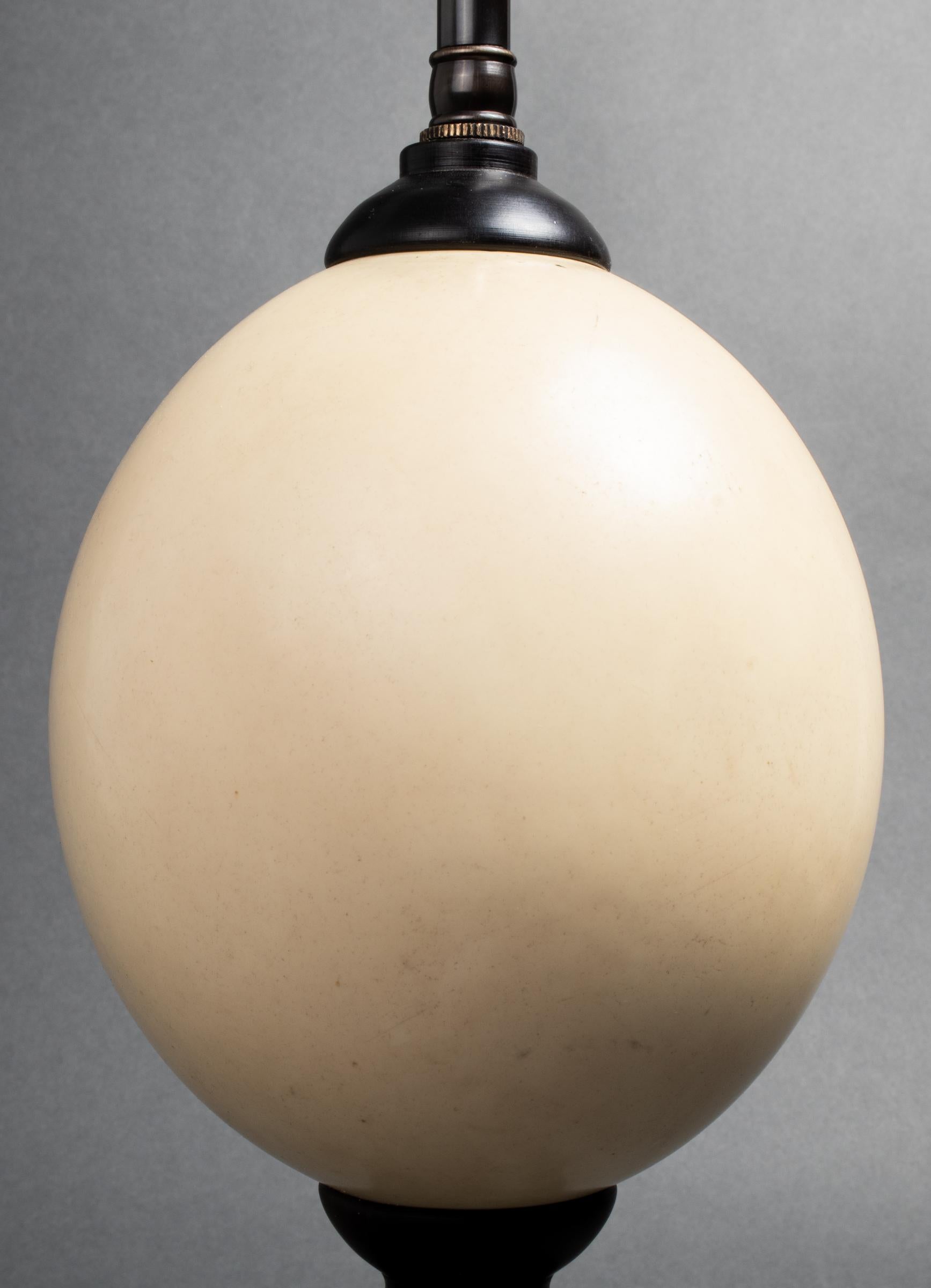 Modern two-light table lamp with ostrich egg base. Measures: 24