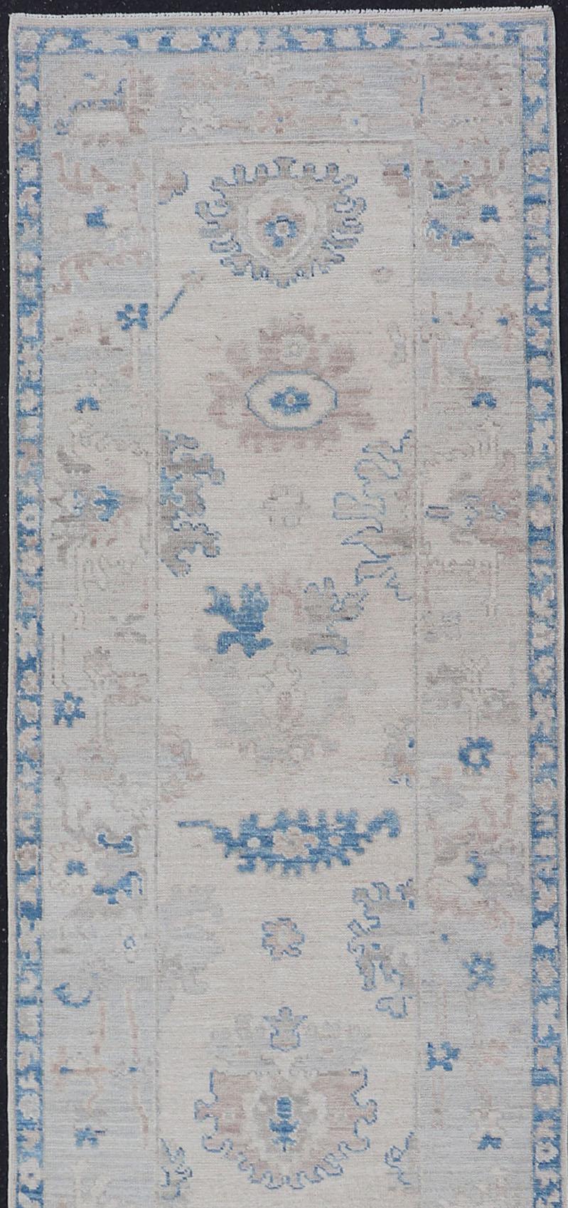 Measures: 2'11 x 12'11 
Modern Oushak All-Over Floral Design Runner In Cream, Tan, and Blue. Keivan Woven Arts; rug AWR-12597 Country of Origin: Afghanistan  Type: Oushak  Circa 2020  Key Words: Medallion Oushak Runner. 

This runner starts in the