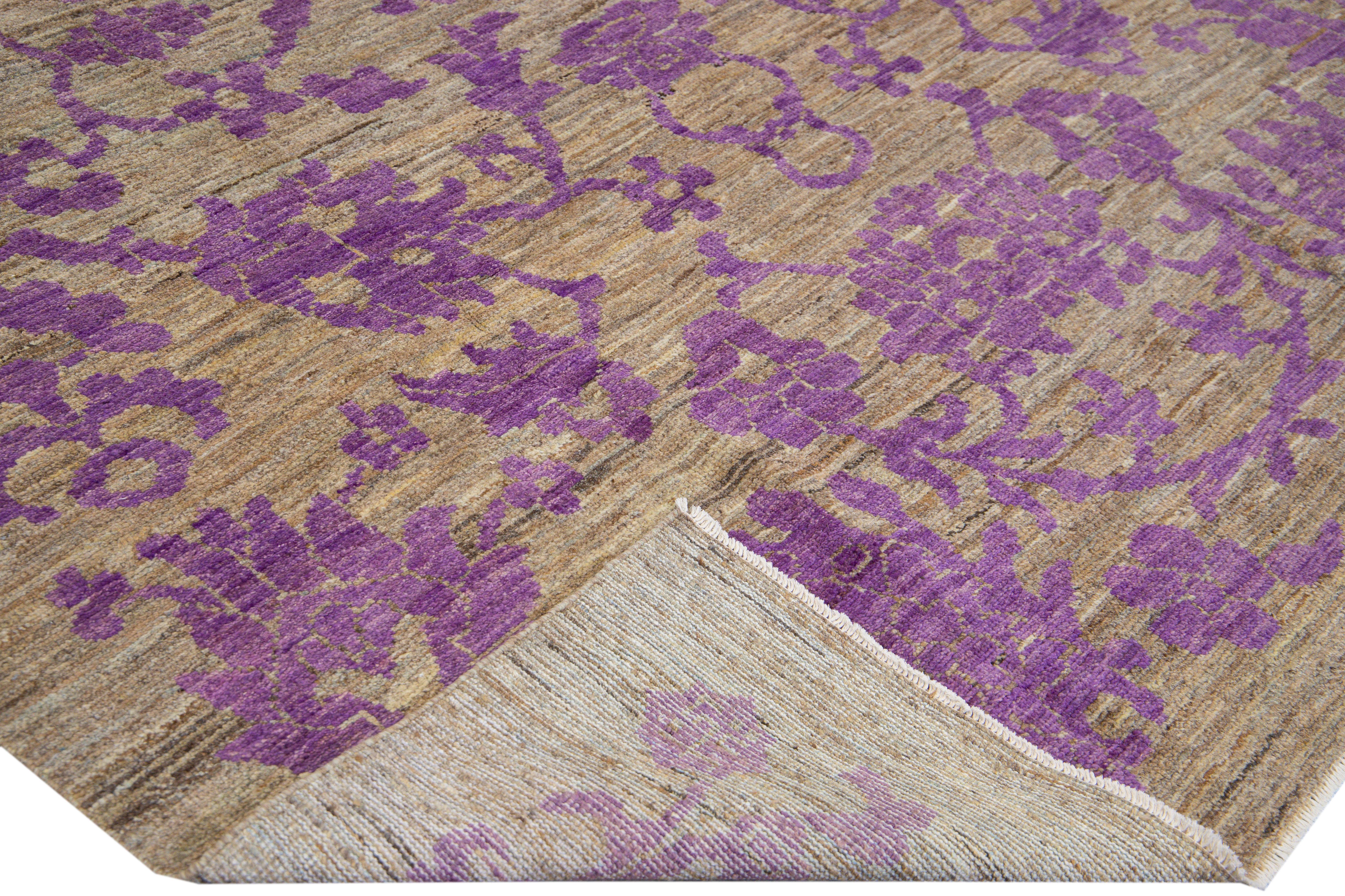 Beautiful modern Oushak hand-knotted wool rug with a brown field. This Oushak rug has a purple accents layout a gorgeous geometric floral pattern design. 

This rug measures: 7'3