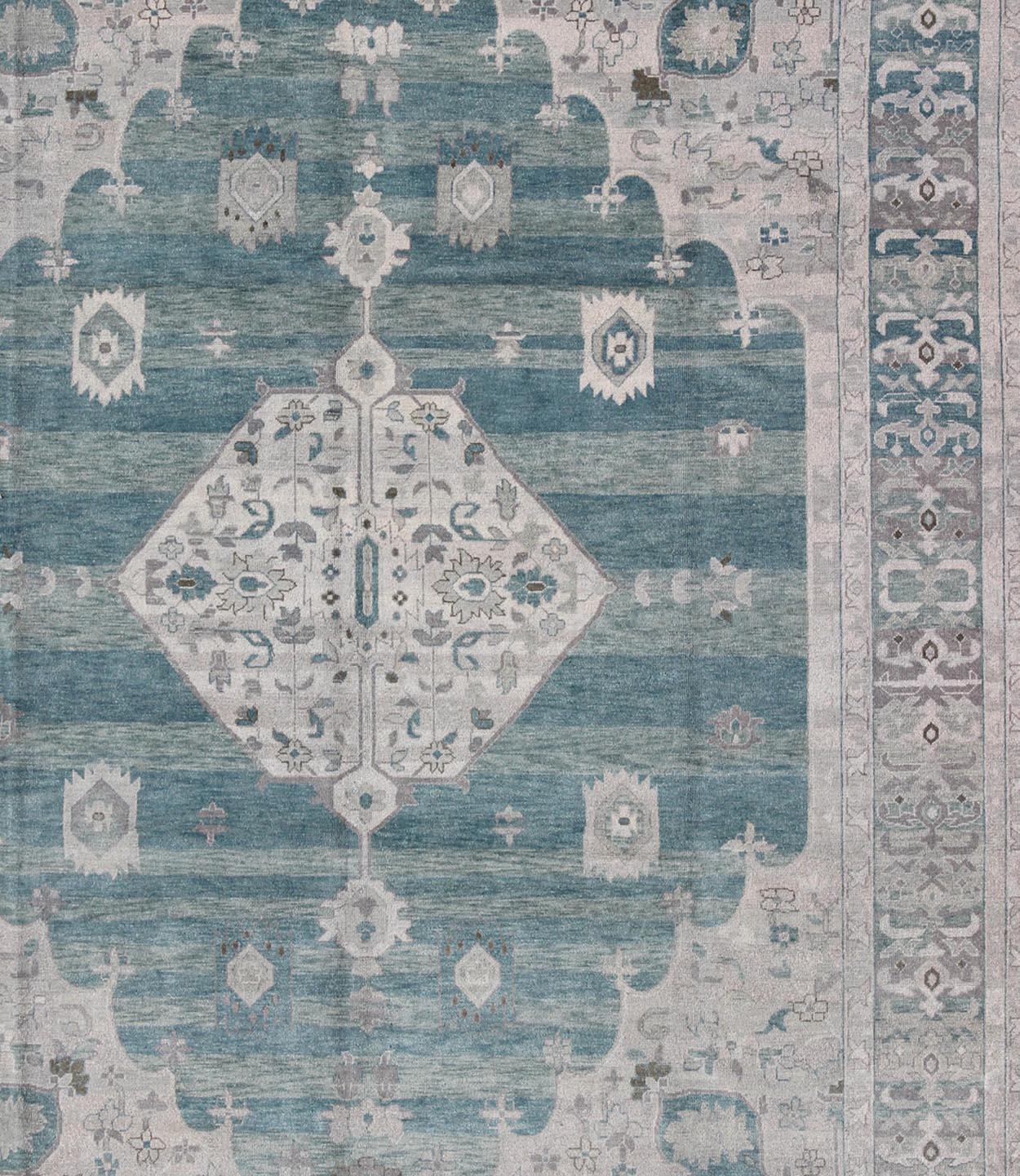 Oushak design in seafoam, silver and shades of gray color palette and center medallion design, Keivan Woven Arts , rug OB-9261028, country of origin / type: India/ Khotan

This hand knotted Oushak rug features a beautiful center medallion design