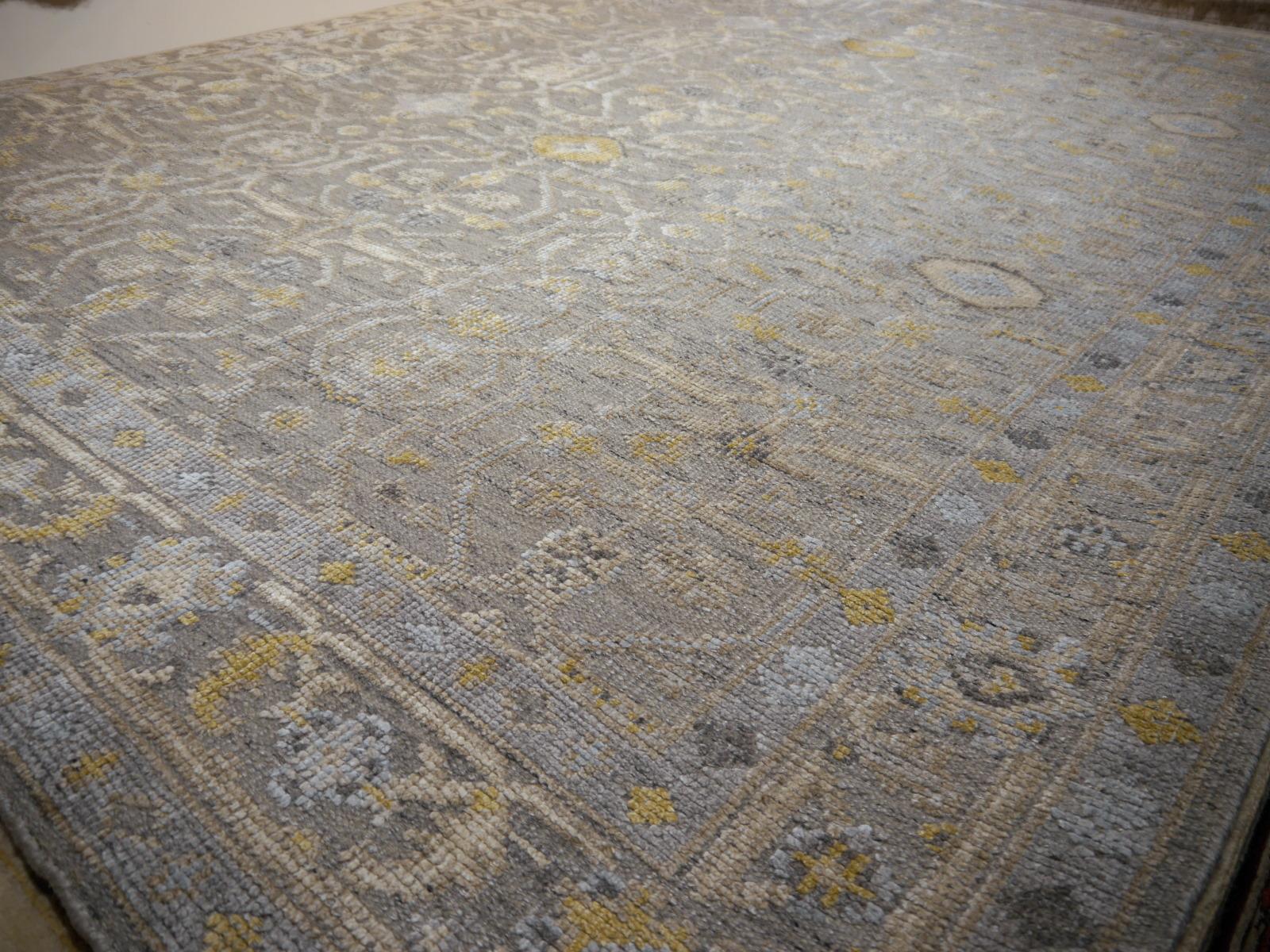 A beautiful 8 x 10 ft. modern Oushak Durva rug hand knotted wool pile and bamboo silk. On a light grey field, the design of traditional Oushak and Heriz elements standing next to each other executed in beiges, blues and grey tones.
Design influences