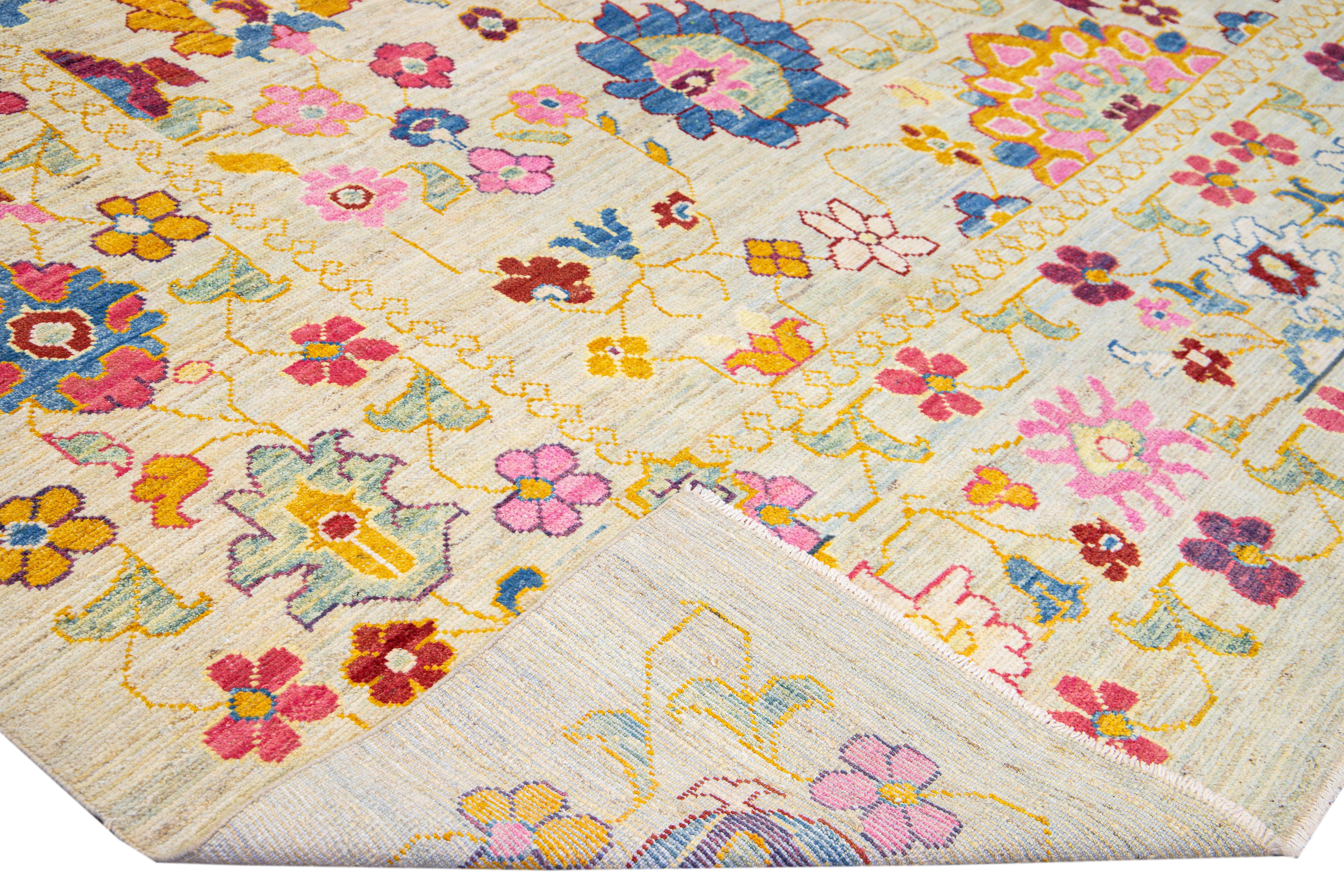 Beautiful modern Oushak hand-knotted wool rug with a beige field. This Oushak rug has a multicolor accents layout a gorgeous geometric floral pattern design. 

This rug measures: 12' x 15'10