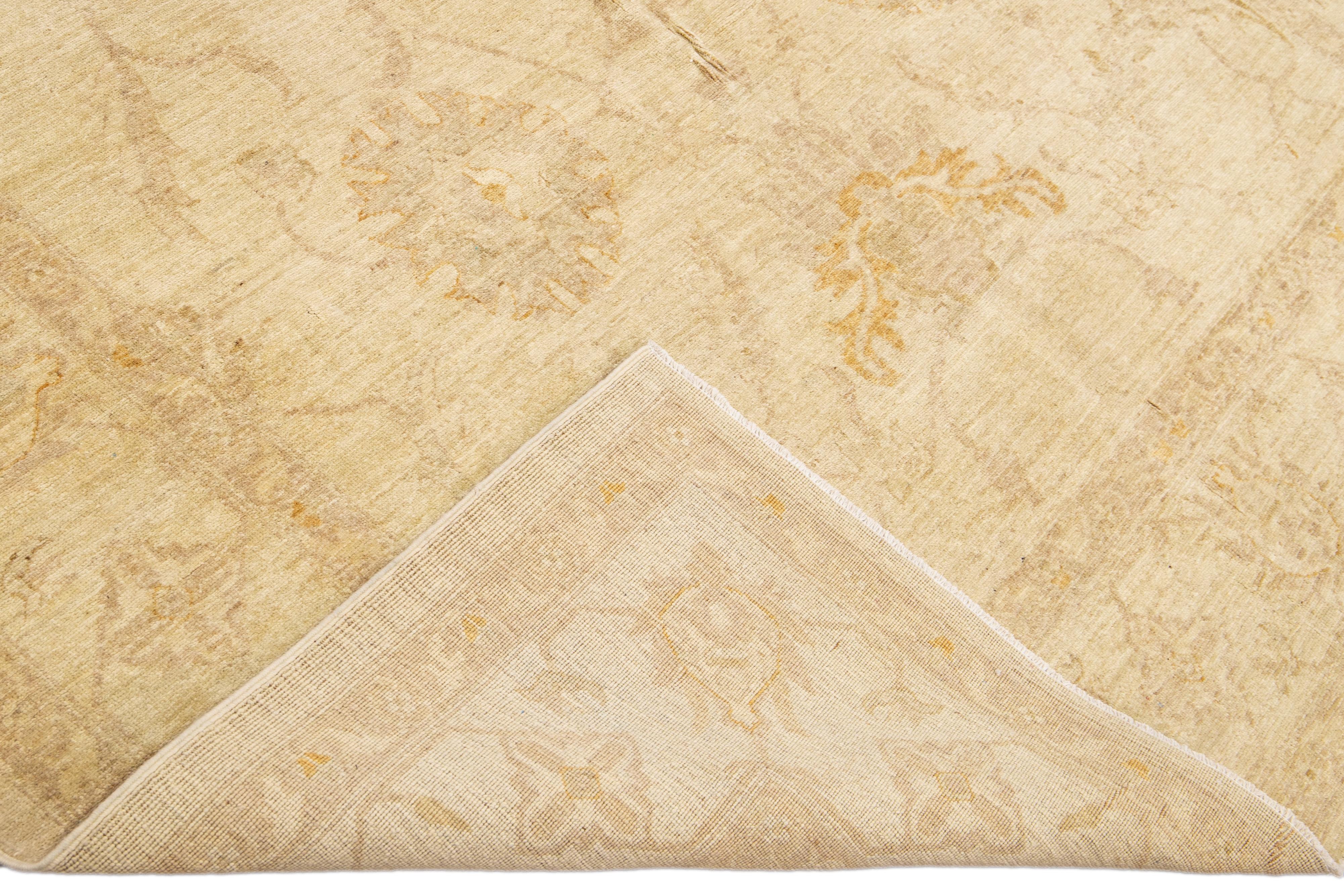 Beautiful modern Oushak hand-knotted wool rug with a beige field. This Oushak rug has brown accents that feature a gorgeous floral pattern design.

This rug measures: 6'10