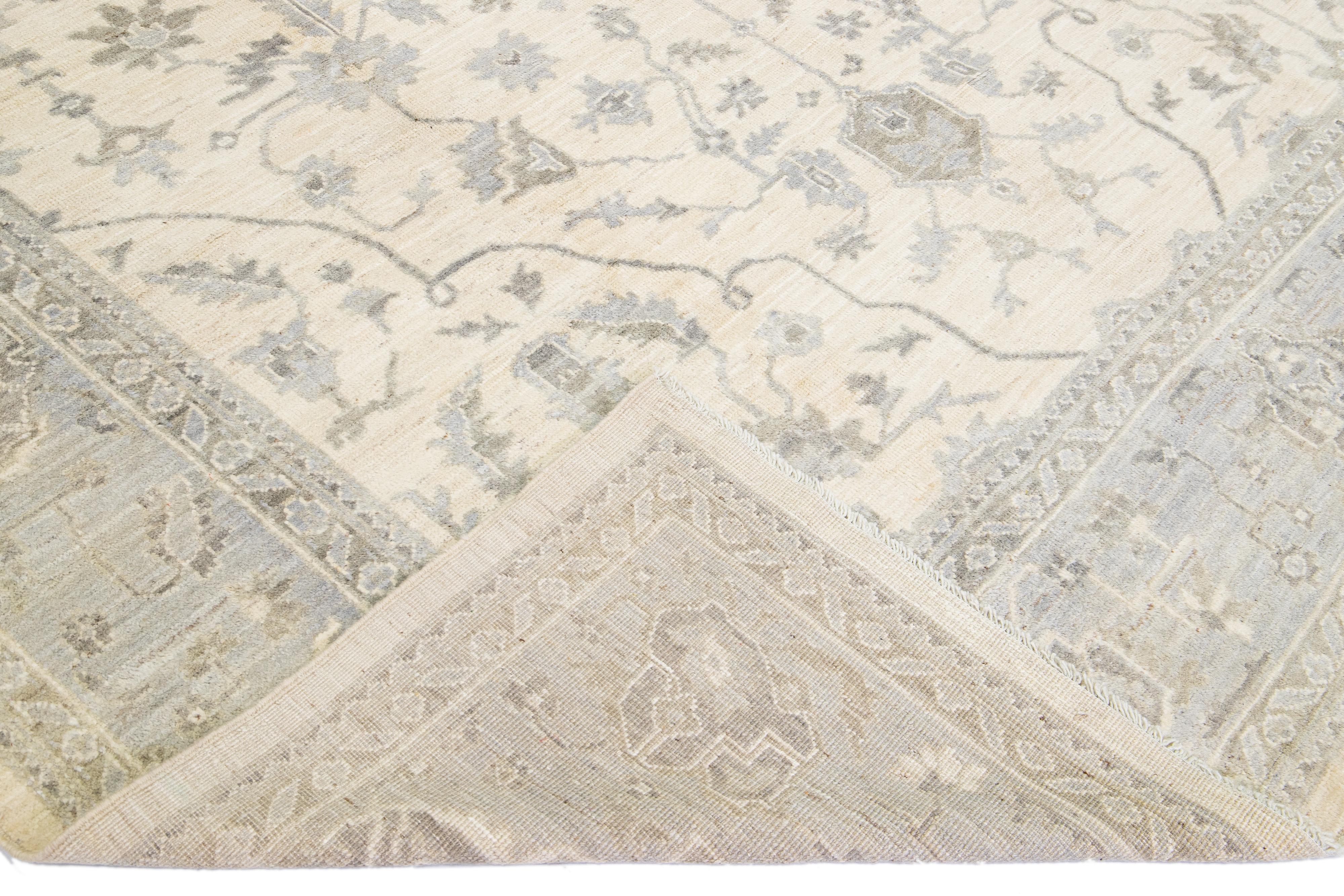Beautiful Oushak hand-knotted wool rug with a beige field. This modern rug has a gray frame and accents of blue and brown in a gorgeous all-over classic medallion motif.

This rug measures: 10'1