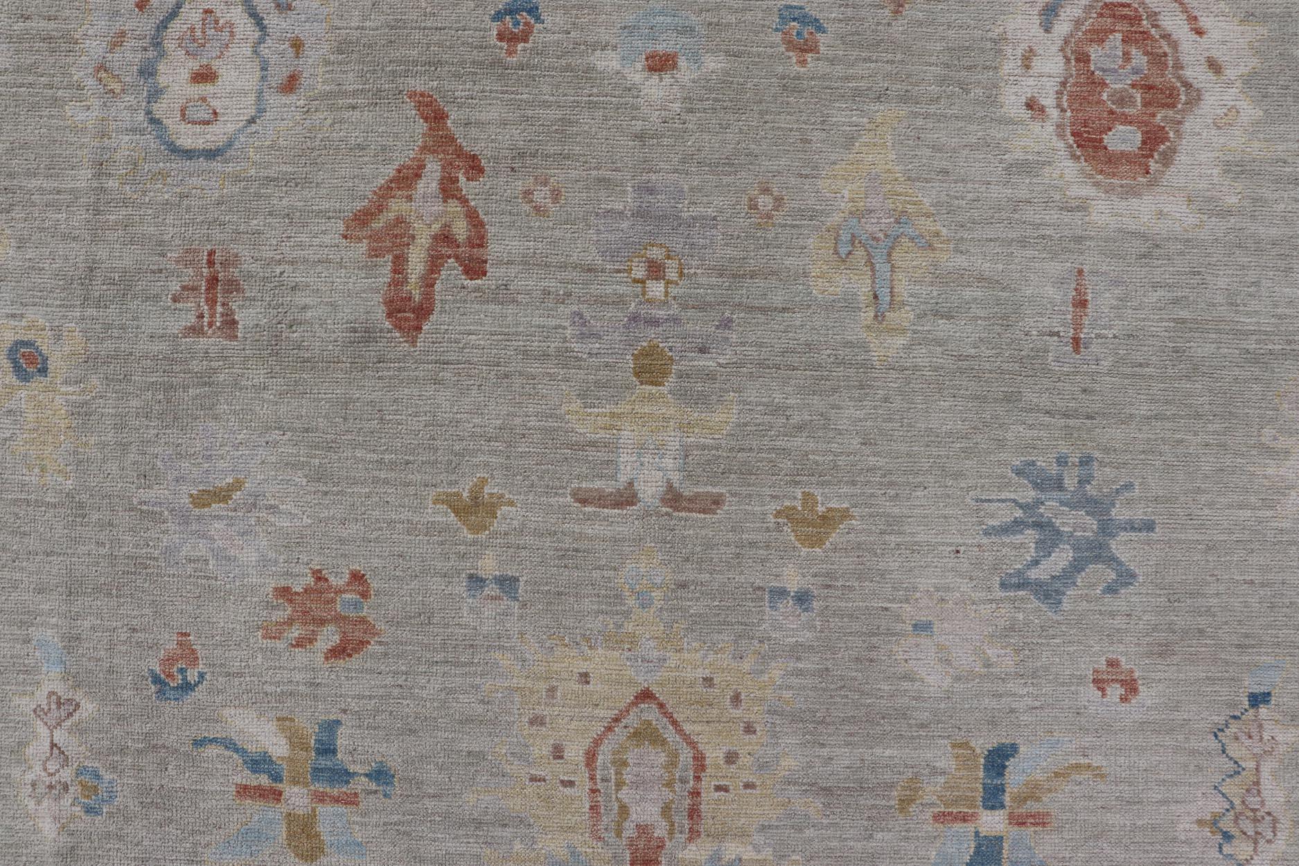 Modern Oushak Floral Motif on Light Taupe Background and Colorful Design. Country of Origin: Afghanistan  Type: Oushak Keivan Woven Arts; rug / AWR-8002,  Design: Floral, All-Over. 21-st Century
 
Measures: 8'0 x 10'2 

The border and background of