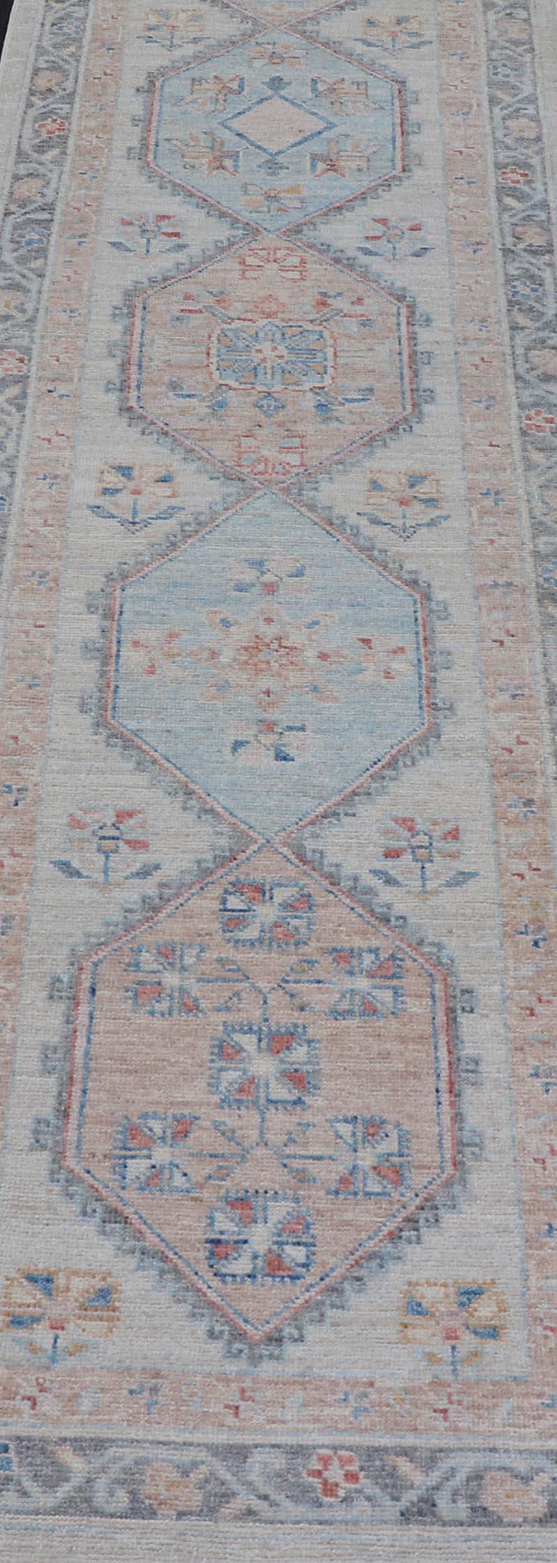 This Oushak presents a floral border on top of a light gray background, accenting colors such as blue, red, and salmon. These mix of tones gives a great contrast to many interiors. 

Measures; 2'7 x 10'6 

Keivan Woven Arts; rug AWR-6290 Country of