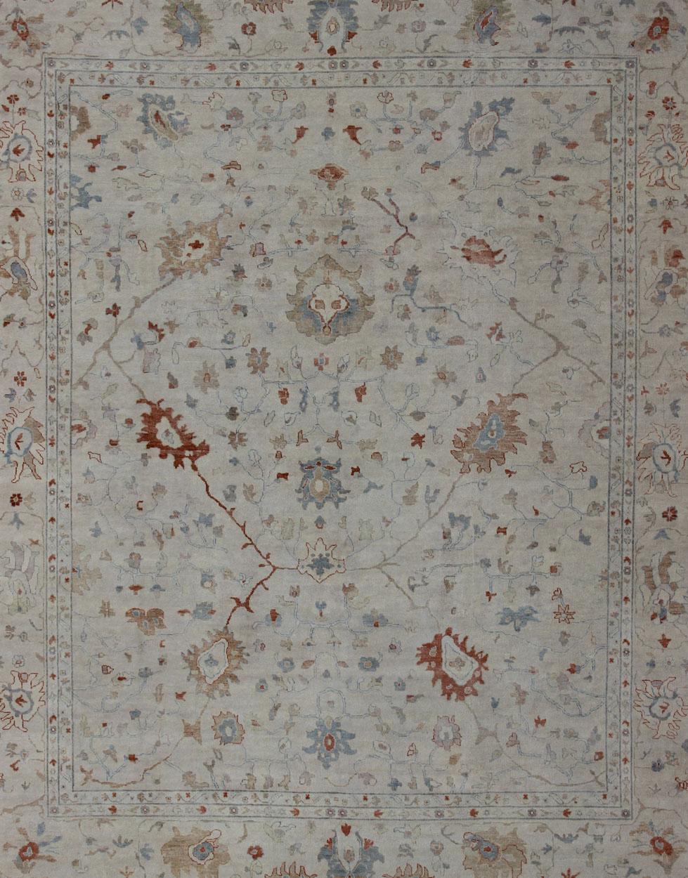 Oushak rug with blue and coral, neutral color palette and all-over flower design, Keivan Woven Arts / rug BDH-742865, country of origin / type: India/ Oushak

This hand knotted Oushak rug features a beautiful design rendered in blue and coral and