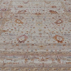 Modern Oushak Muted Rug in Earthy Tones on a Cream Background