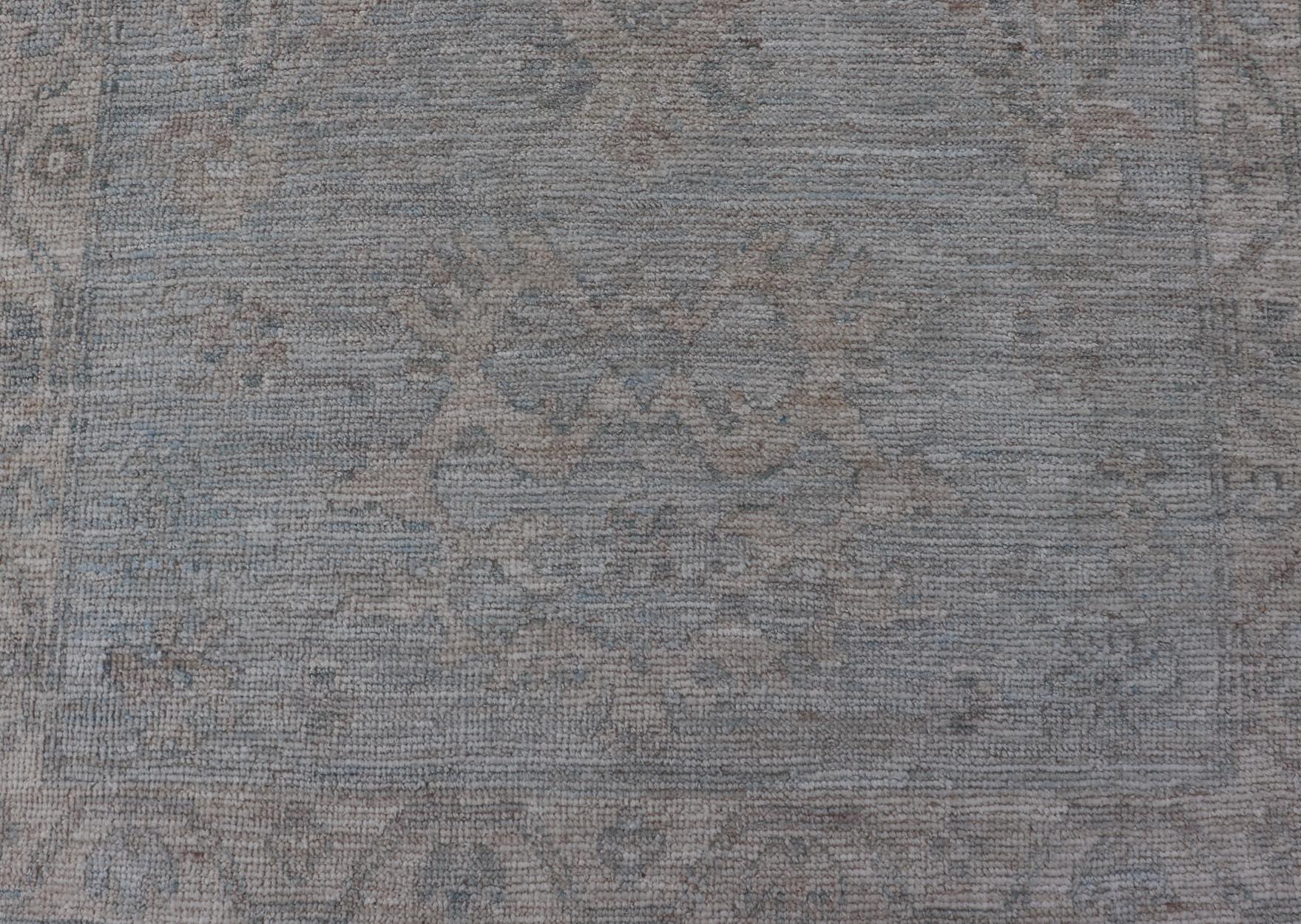Modern Oushak Rug in All-Over Floral Motifs in Light Blue-Gray and Creams. Keivan Woven Arts; rug AWR-16788 Country of Origin: Afghanistan Type: Oushak Design: All-Over, Floral. 
Measures: 2'11 x 5'3 
hand knotted in wool, this rustic looking