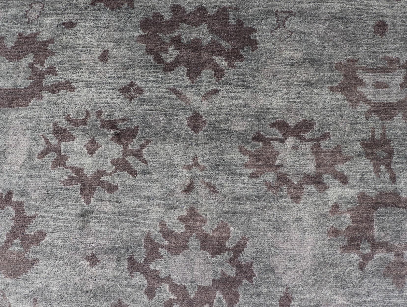 Tappeto Oushak moderno annodato a mano in lana con disegni sub-geometrici in verde e marrone. 
Misure: 9'3 x 13'9.    
Questo moderno tappeto indiano Oushak è stato annodato a mano in lana e presenta un disegno sub-geometrico nei toni del verde e