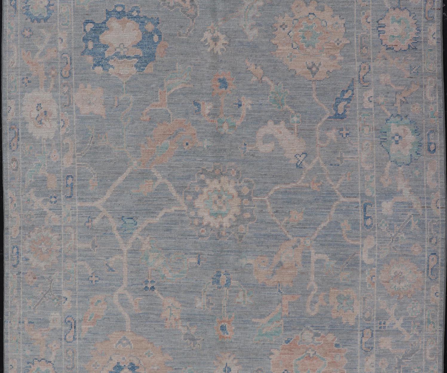 Modern Oushak Rug With in Light Gray Blue Background and All-Over Floral Motifs. Keivan Woven Arts; rug AWR-8052 Country of Origin: Afghanistan Type: Oushak Design: All-Over, Floral 
Measures: 5'11 x 9'1 
Hand-Knotted in Afghanistan, this antique
