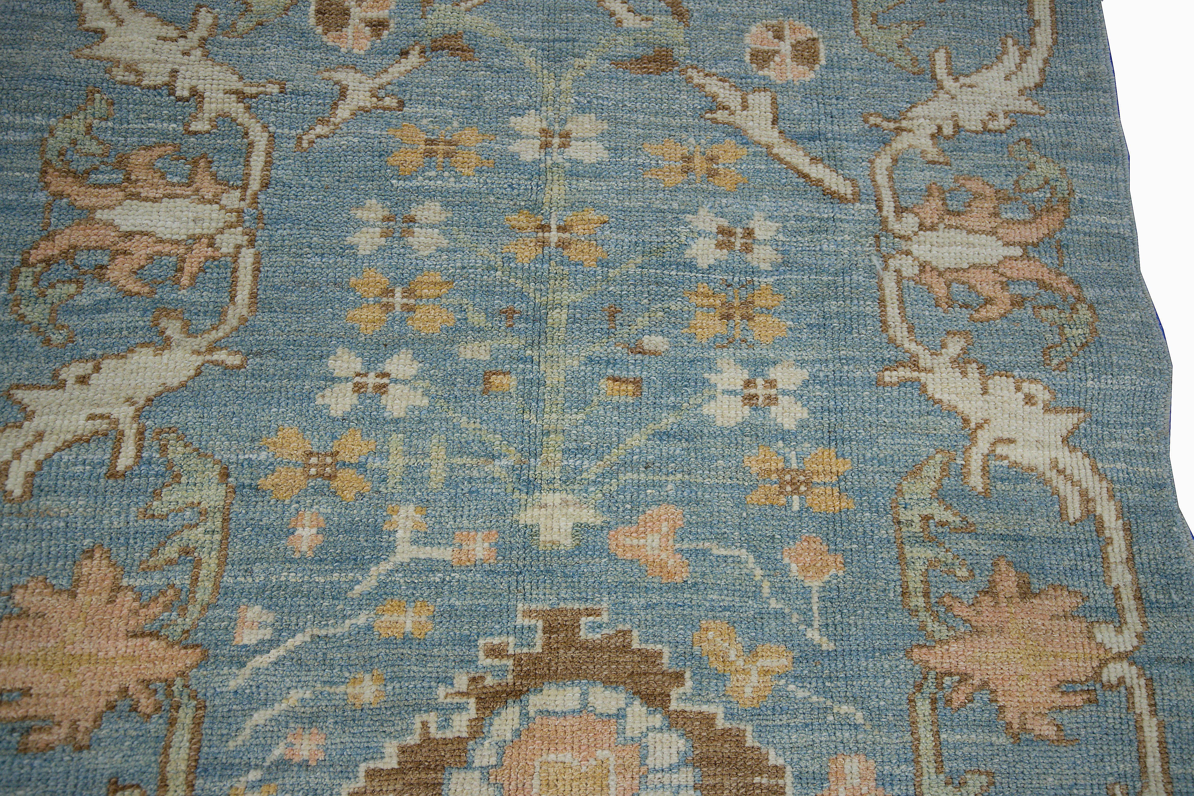 Modern Turkish rug made of handwoven sheep’s wool of the finest quality. It’s colored with organic vegetable dyes that are certified safe for humans and pets alike. It features a lovely blue field with floral details in ivory, brown and orange