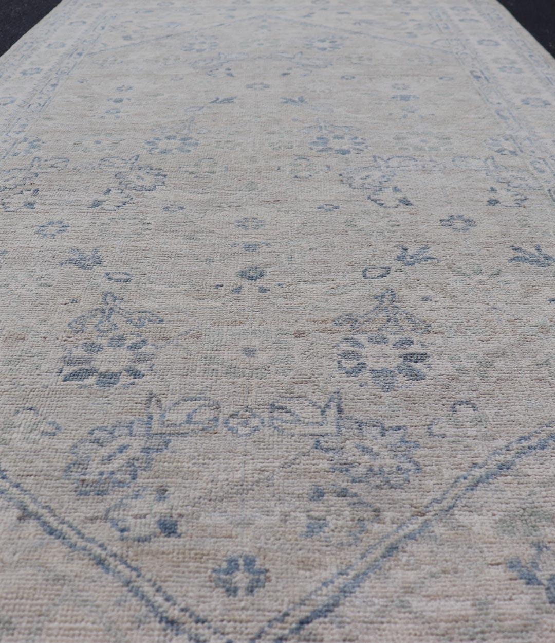 Measures: 3'10 x 8'2 
Modern Oushak Rug with Soft Ivory Base and Subtle Sky Blue Accents 3'10 x 8'2. Keivan Woven Arts; rug AWR-87 Country of Origin: Afghanistan Type: Oushak Design.

A serene and elegant Modern Oushak rug that blends classic design