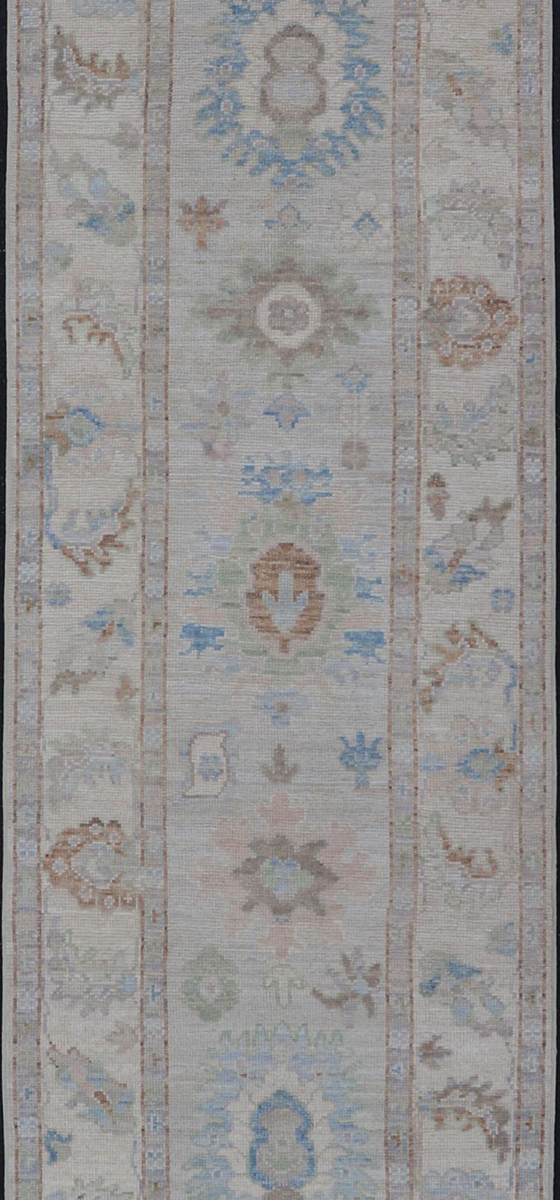 Wool Modern Oushak Runner on Light Cream Field and Colorful Motifs Of Blue & Green For Sale