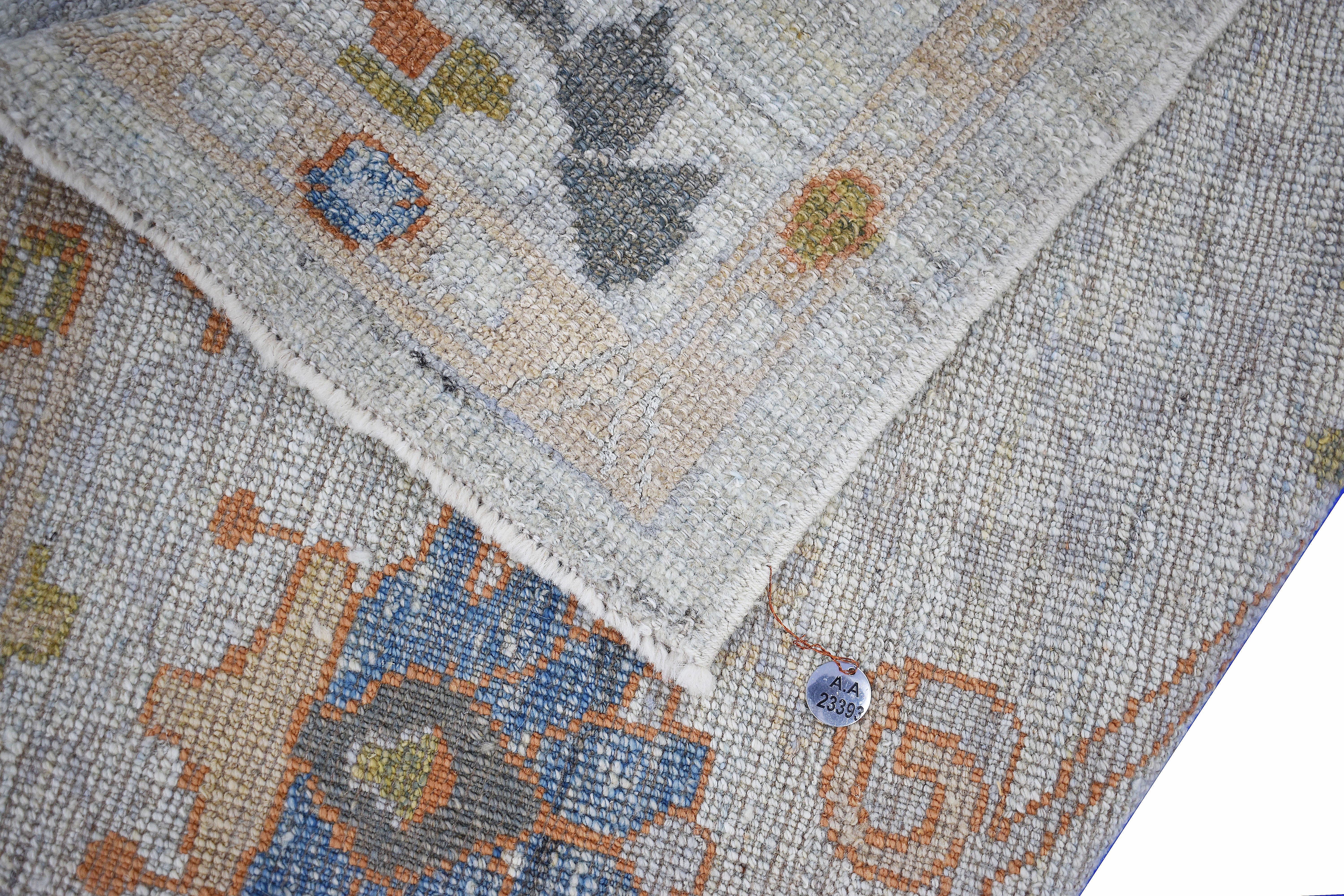 Modern Turkish runner rug made of handwoven sheep’s wool of the finest quality. It’s colored with organic vegetable dyes that are certified safe for humans and pets alike. It features a gorgeous gray field with floral details in brown and navy