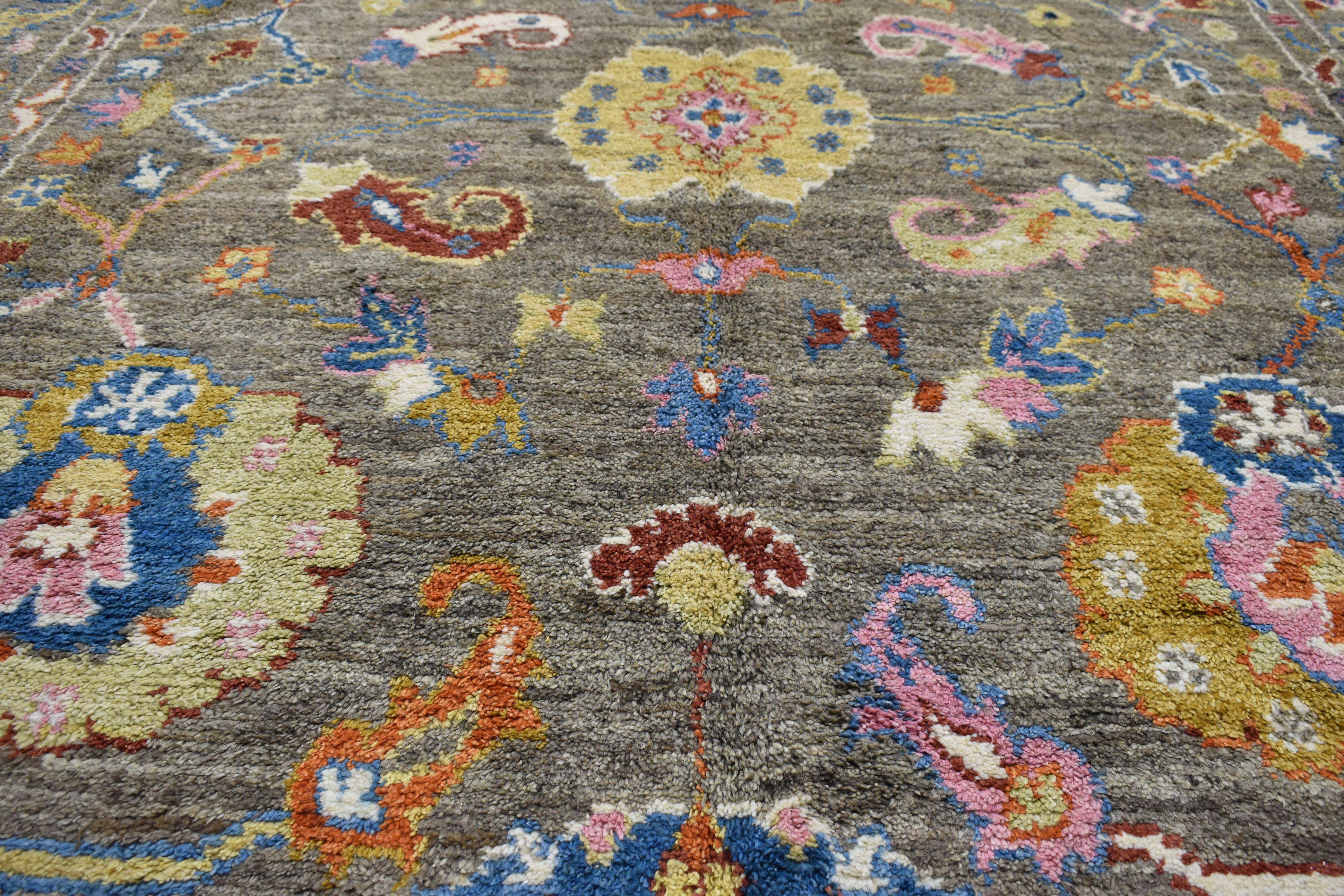 Providing elements of wanderlust and functional versatility, this modern Oushak style rug with bright colors displays a combination of exquisitely balanced designs creating a tastefully casual space with a robust combination of texture and pattern.