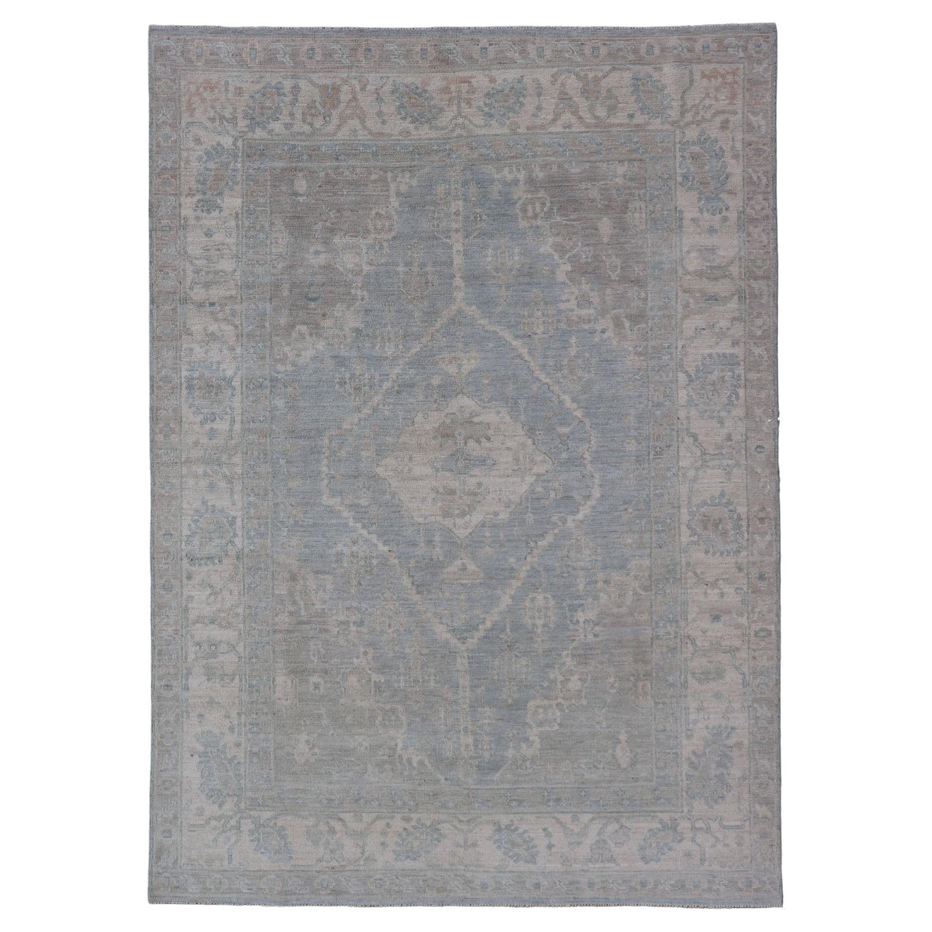 Modern Oushak with a Light Blue-Gray Background with Medallion & Tribal Motifs