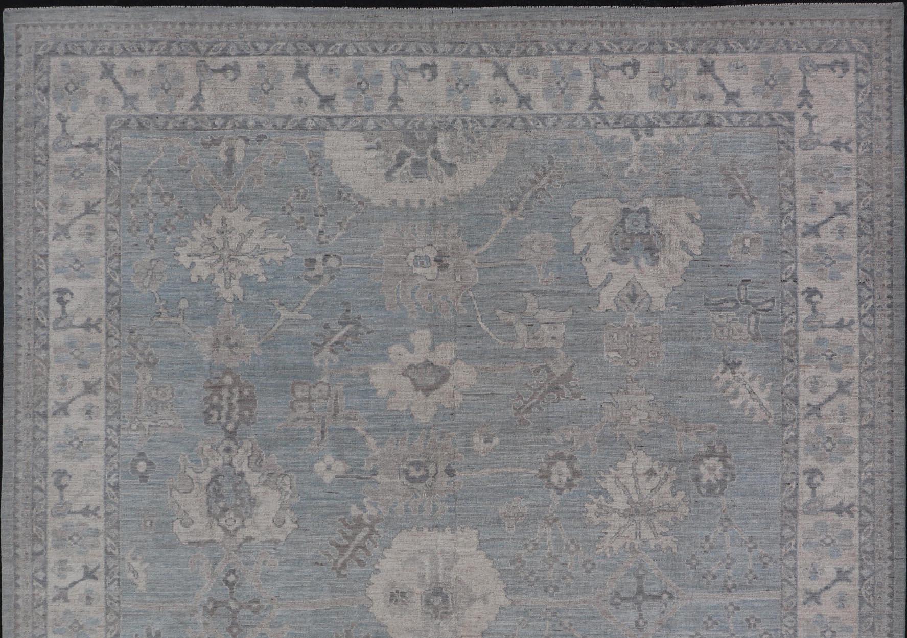Modern Oushak with Floral and Tribal Motifs with Cream, Gray and Powder Blue.
Keivan Woven Arts; rug AWR-8234 Country of Origin: Afghanistan Type: Oushak Design: Floral, All-Over Abstract-Tribal 21st Century 
Measures: 9'11 x 13'10 
This modern