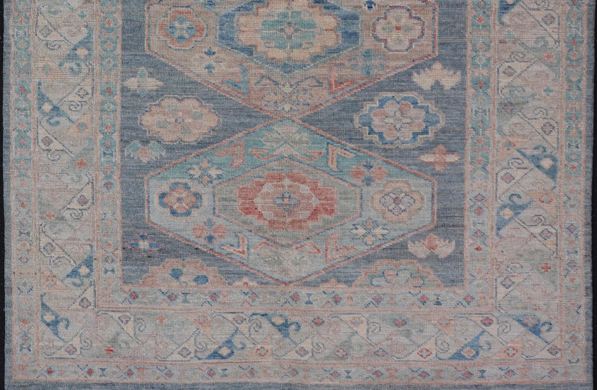 Modern Oushak With Large Medallion Design on A Blue-Gray Field. Keivan Woven Arts; rug AWR-8184 Country of Origin: Afghanistan Type: Oushak Circa 2020 
Measures: 5'2 x 7'0 
This modern Oushak features large medallions in the center of a blue-gray