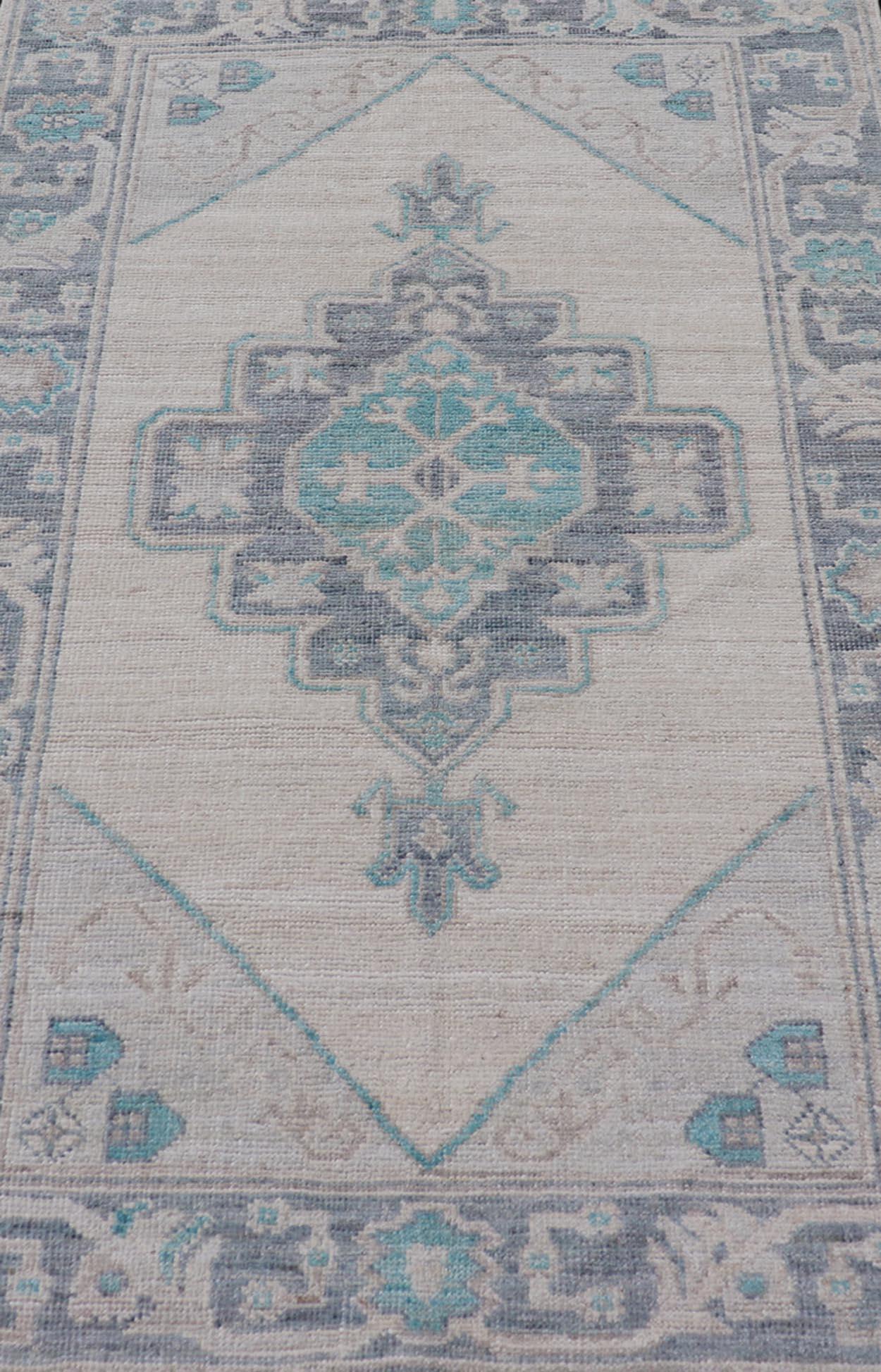 Afghan Modern Oushak with Off White Background with A Large Tribal Medallion in Teal  For Sale
