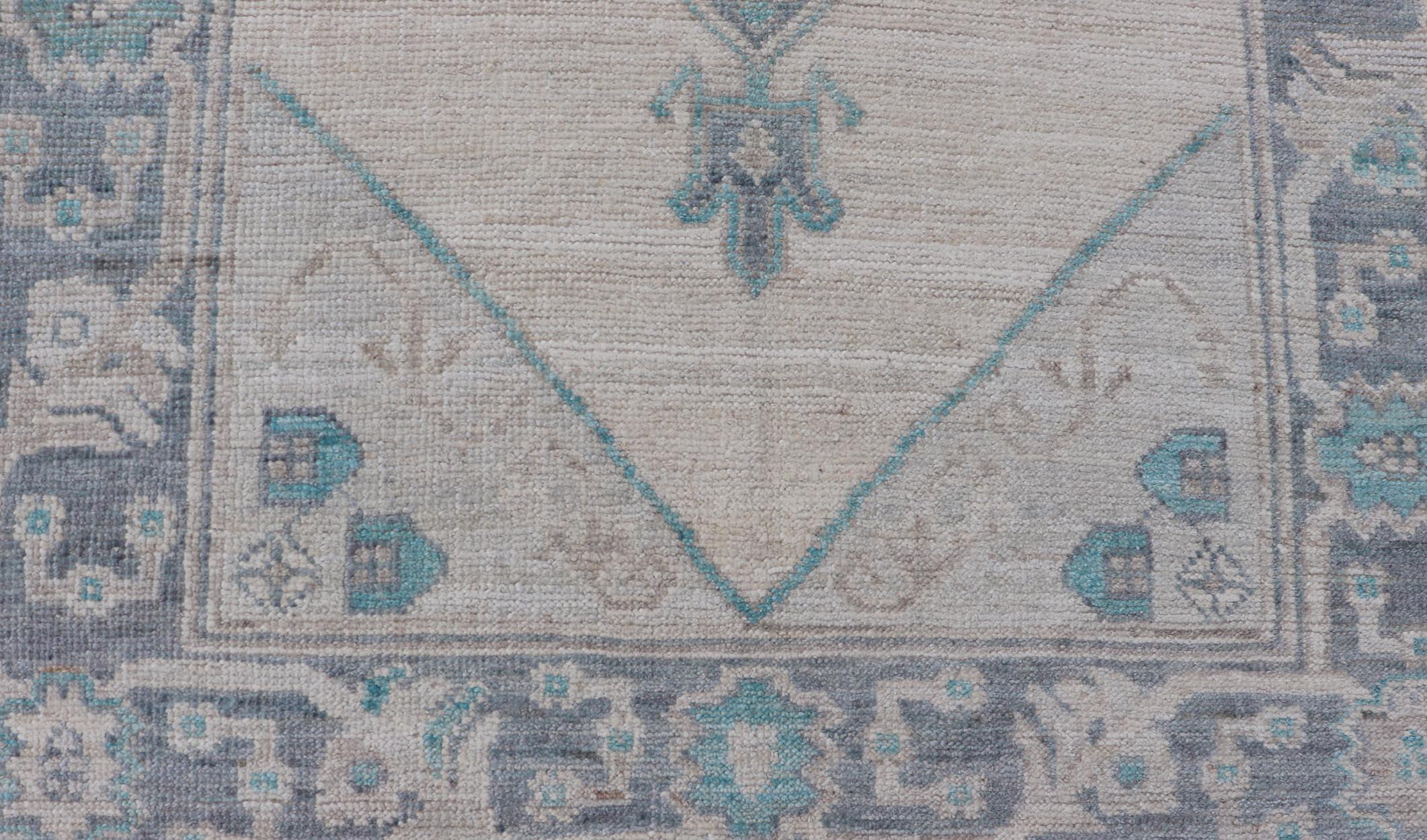 Wool Modern Oushak with Off White Background with A Large Tribal Medallion in Teal  For Sale