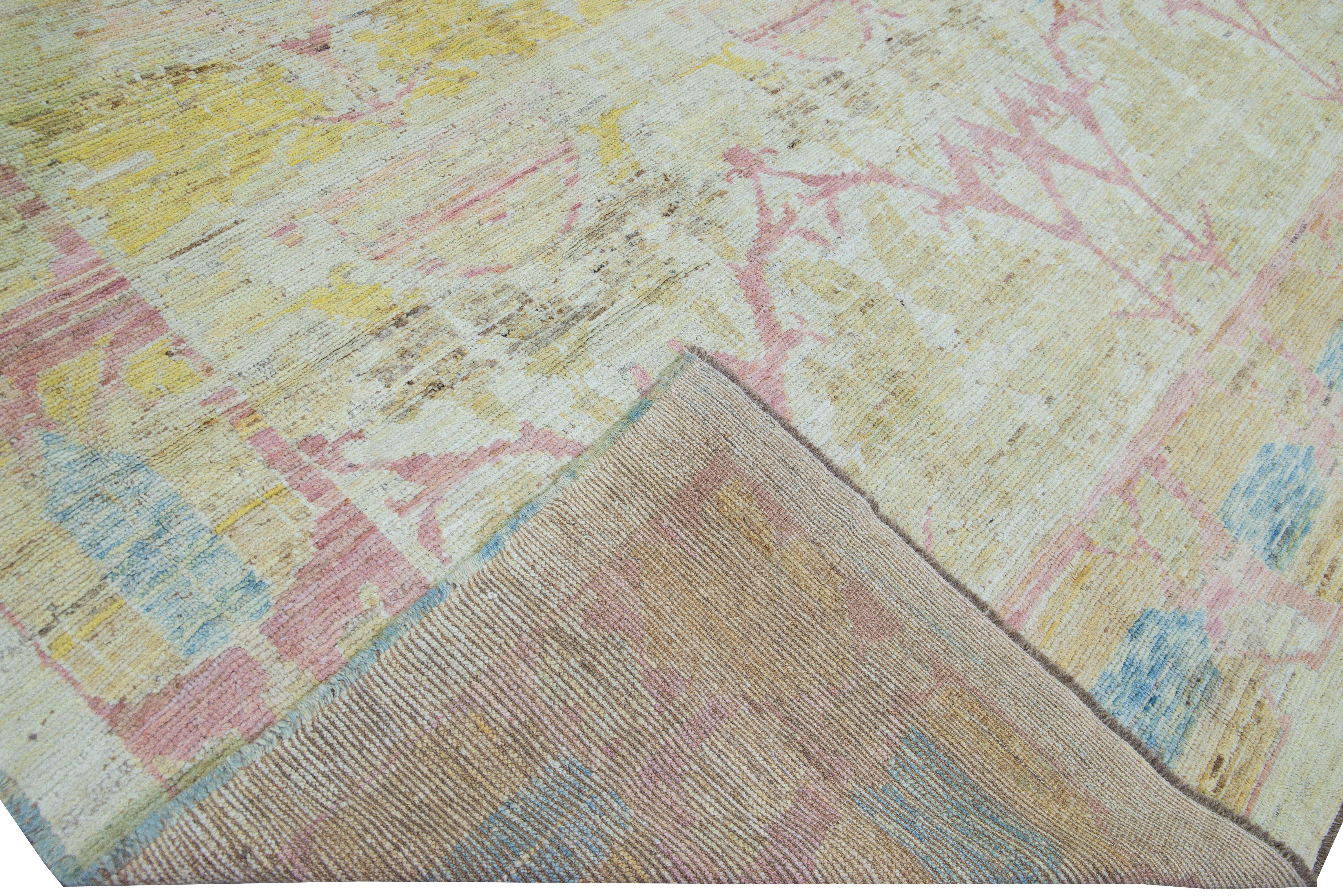 Beautiful Modern Oushak hand-knotted wool rug with a yellow gradient field. This Oushak rug has blue, pink, and ivory accents all over a gorgeous geometric floral pattern design. 

This rug measures: 11' x 15'2