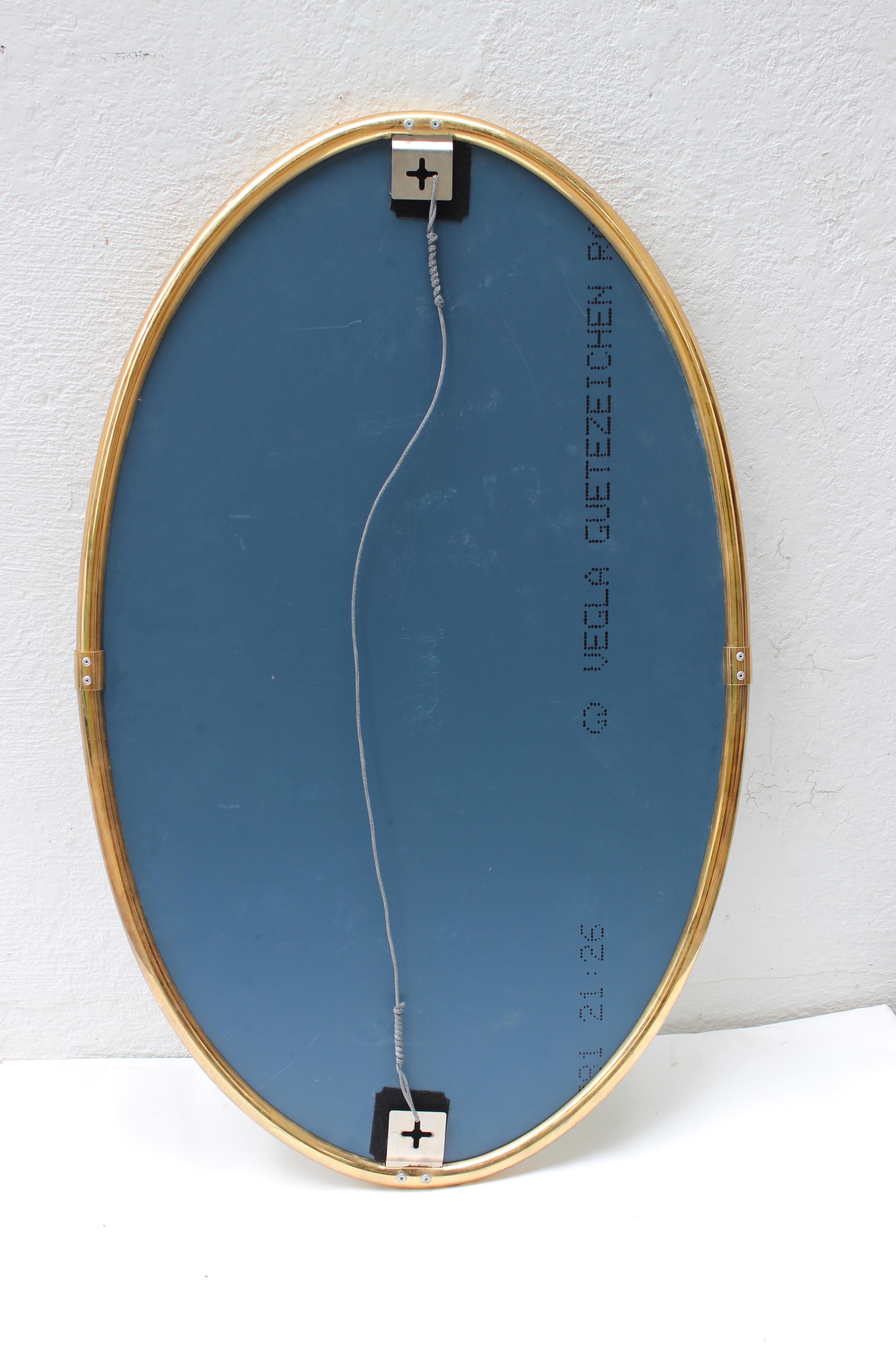 Modern oval brass mirror.