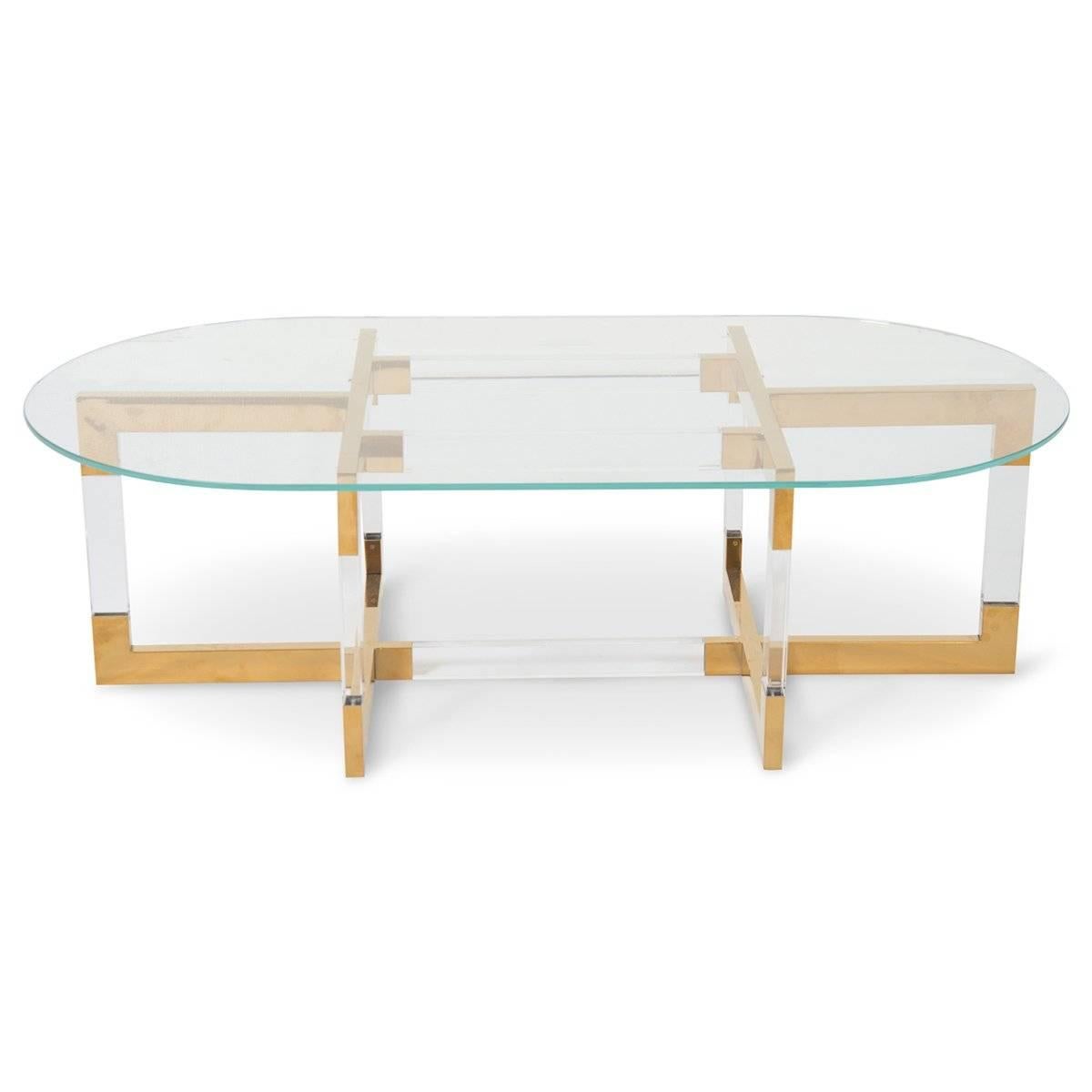 Our new trousdale two coffee table features Lucite and brass in a criss-cross design. Shown with our oval glass top. 

Dimensions:
53