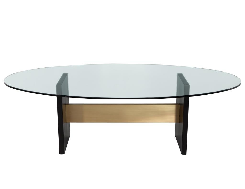 Introducing the newest addition to our collection of modern dining tables – the Modern Oval Glass Top Dining Table, handcrafted by the skilled artisans at Carrocel. This stunning piece features an elegant oval shaped glass top, perfect for intimate
