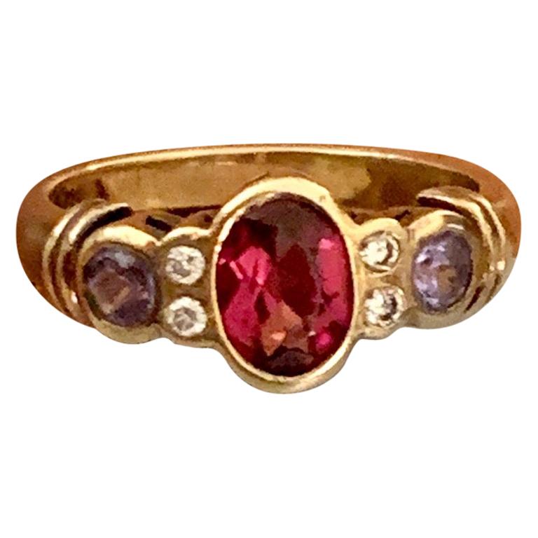 Modern Oval Rhodolite Garnet, Tanzanite and Diamond 14 Karat Yellow Gold Ring