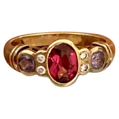 Vintage Modern Oval Rhodolite Garnet, Tanzanite and Diamond 14 Karat Yellow Gold Ring