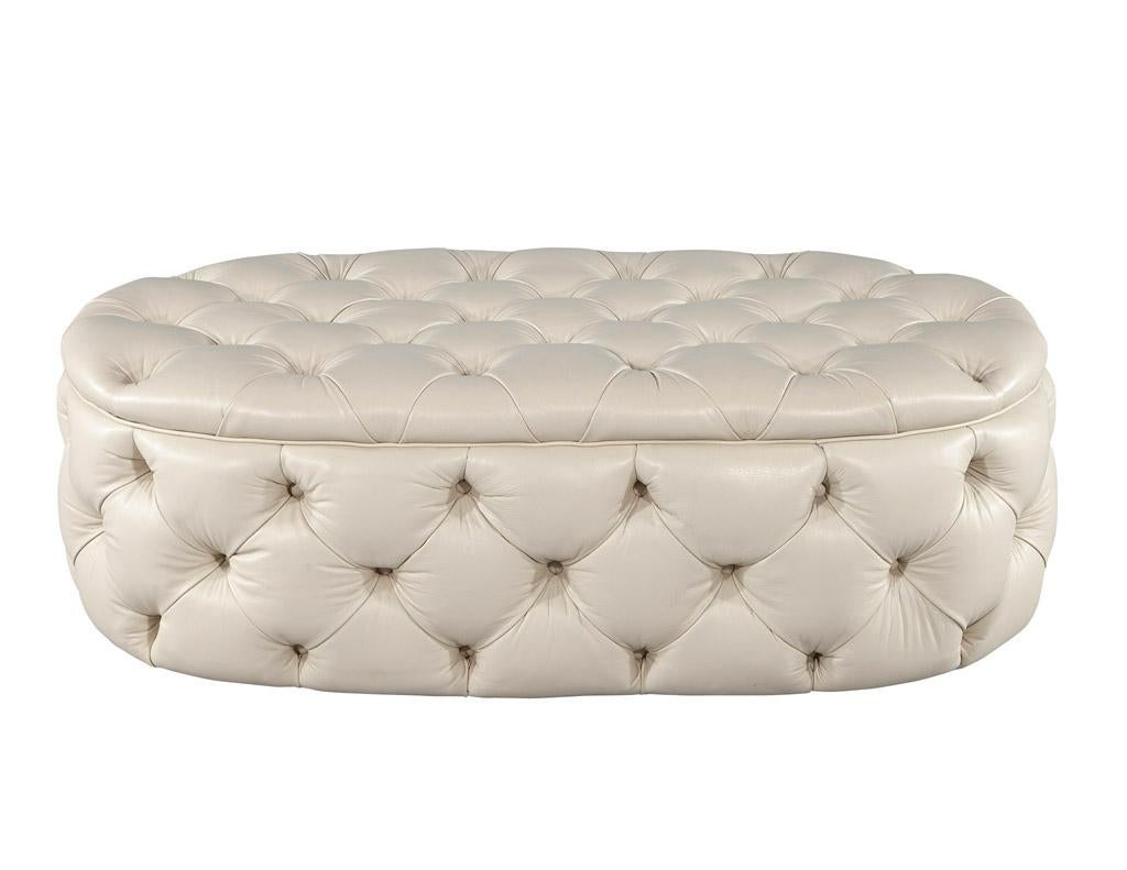This modern oval tufted leather ottoman is the perfect addition to your living space. With its classic tufted design and luxurious Italian leather, it will bring a touch of sophistication to any room. The ottoman is upholstered in a creamy, neutral