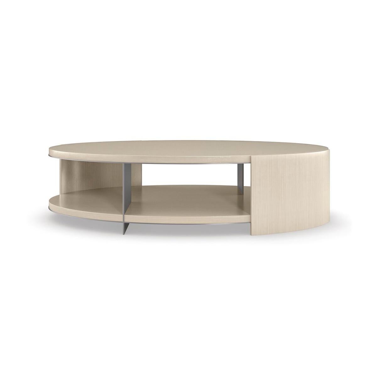 With a refined oval shape, this cocktail table is a captivating addition to living interiors. Elevating its simple form, a Thunder finish gives light to the linear wood grain, accentuated by metal trim in soft silver paint.

Like a work of art,