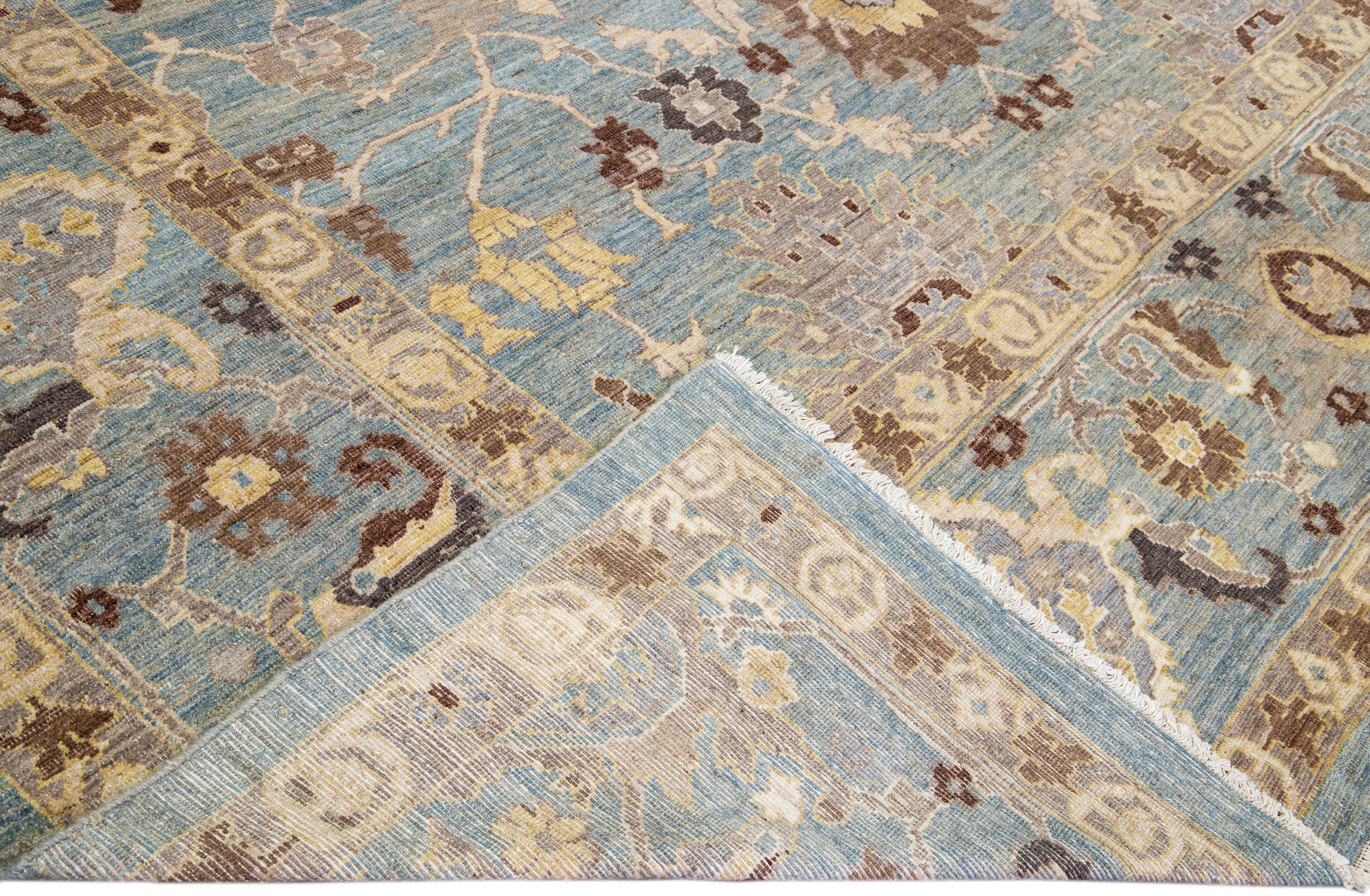 Beautiful modern Sultanabad hand-knotted wool rug with a blue field. This Sultanabad rug has brown, yellow, and beige accents in a gorgeous all-over Classic floral pattern design.

This rug measures: 12'5