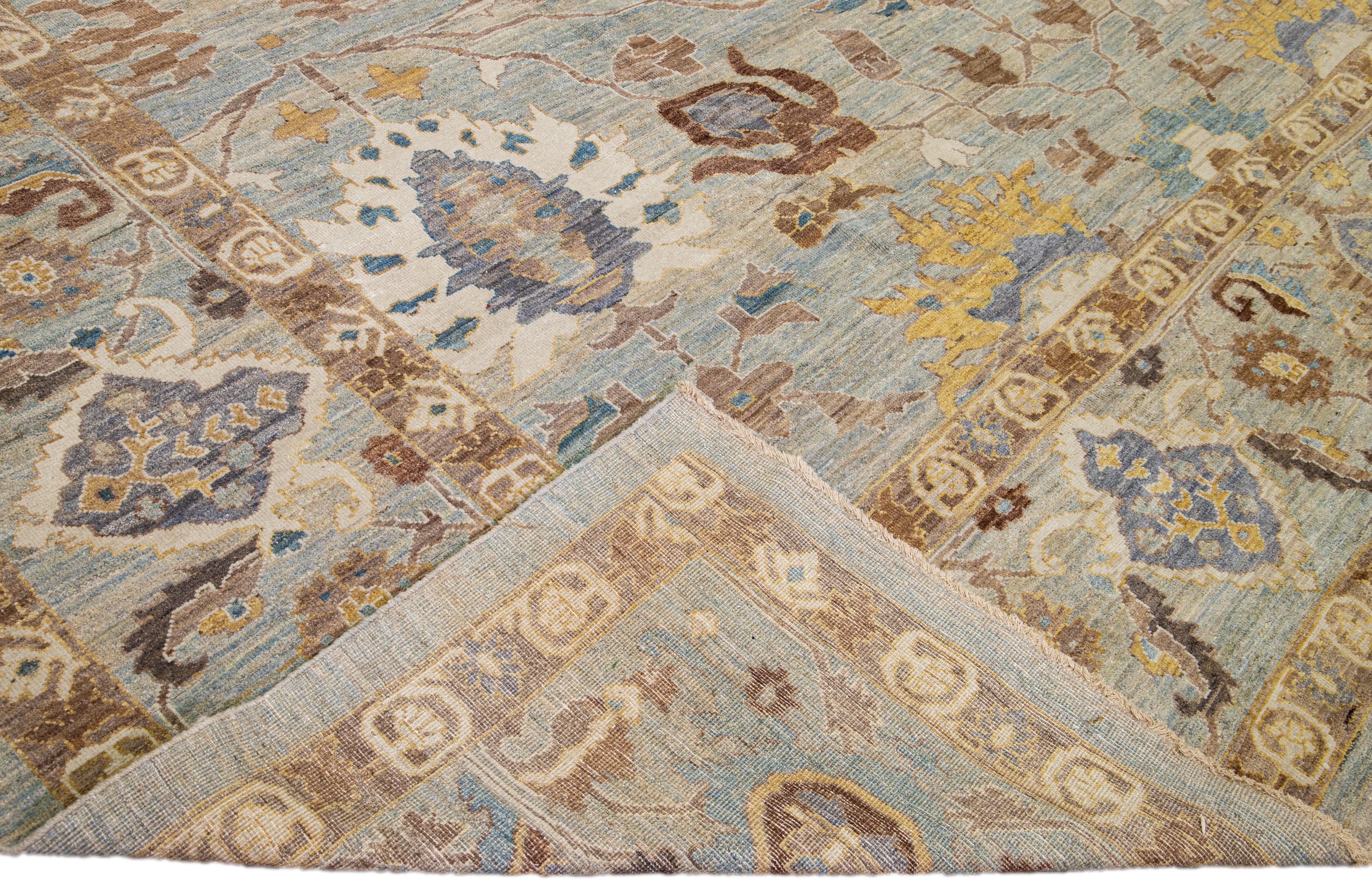 Beautiful modern Sultanabad hand-knotted wool rug with a blue and gray field. This Sultanabad rug has brown, goldenrod, and blue accents in a gorgeous all-over Classic floral pattern design.

This rug measures: 14'3