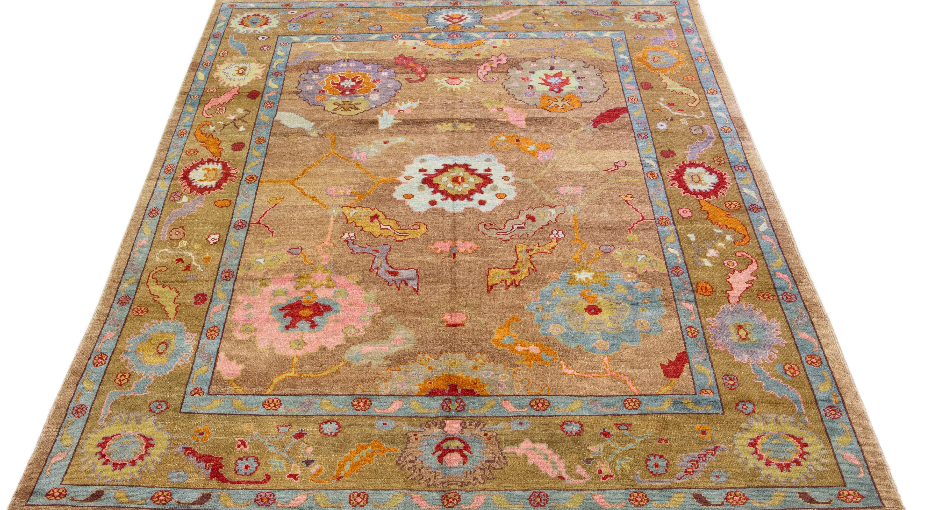 Beautiful modern Turkish Kars hand-knotted wool rug with a tan color field. This Turkish rug has a gorgeous floral pattern design with blue, pink, orange, and green accents.

This rug measures: 10' x 15'1