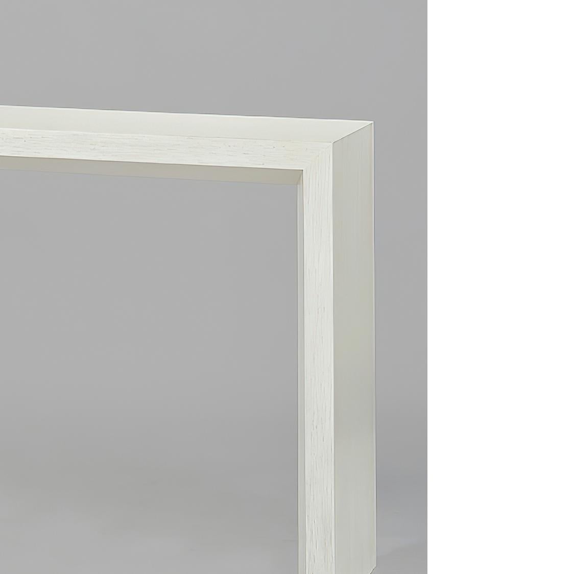 Modern painted console table with a beveled shape on the inside legs and lower side of the top, and a “drift” white painted finish with subtle grey distressing.

Dimensions: 64