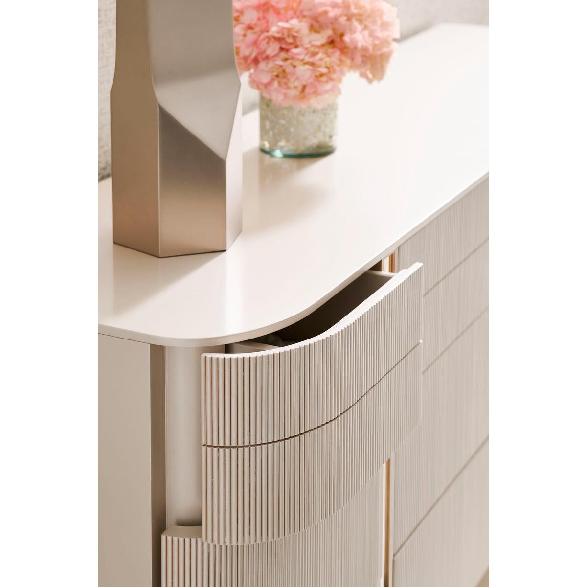 Representing the ultimate combination of form and function, it creates a space worthy of your finest clothing. All drawers are completely finished and wear Matte Pearl.

The gracefully rounded profile of its fashion-forward design adds visual appeal